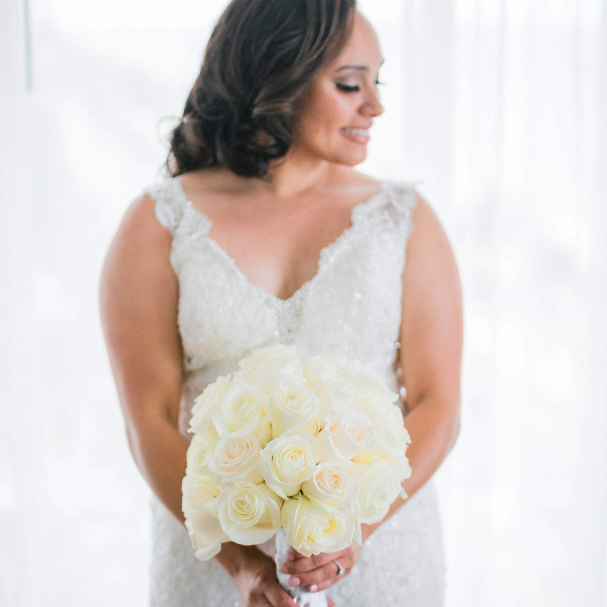 Bride holding a white rose bouquet