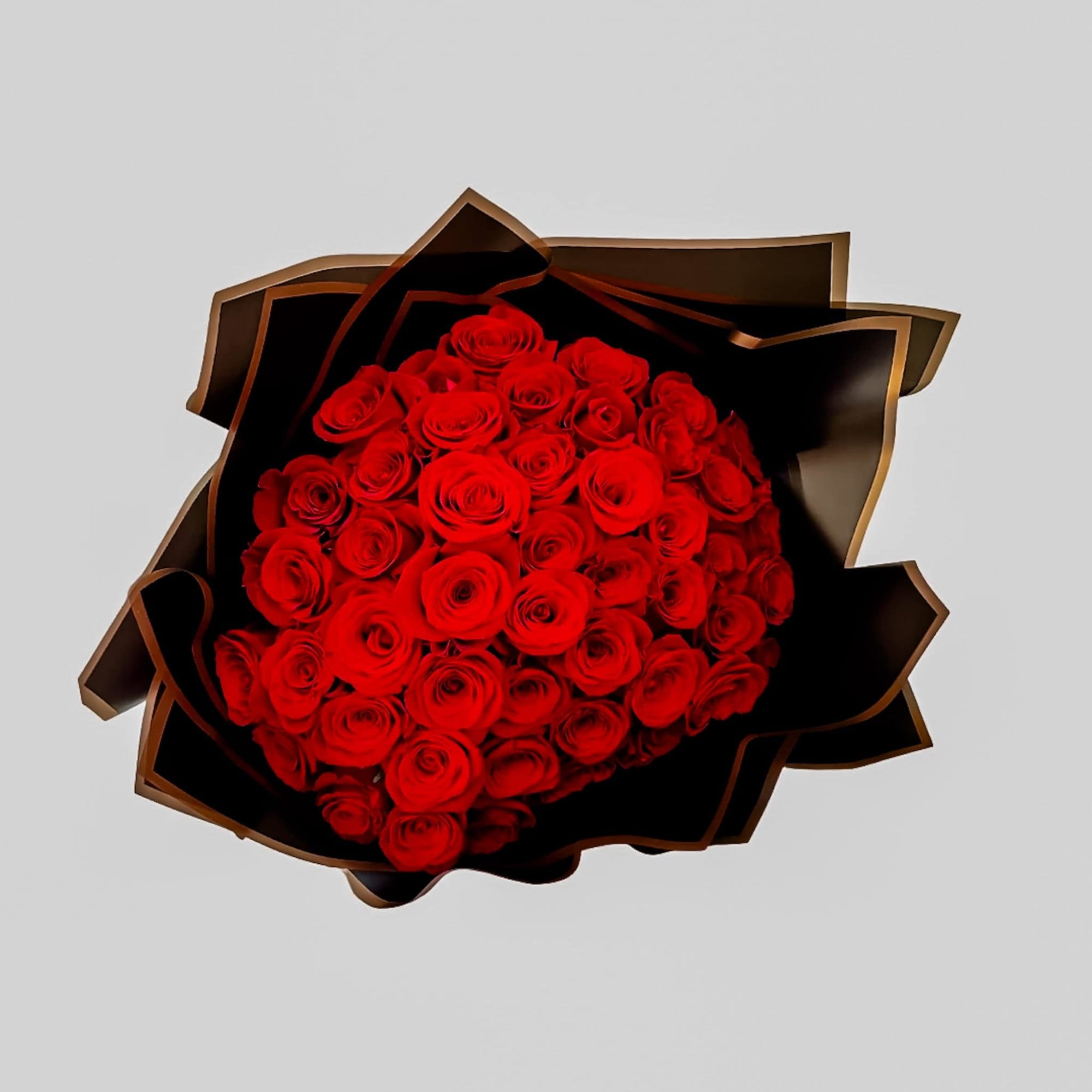 Bouquet of red roses wrapped in black paper
