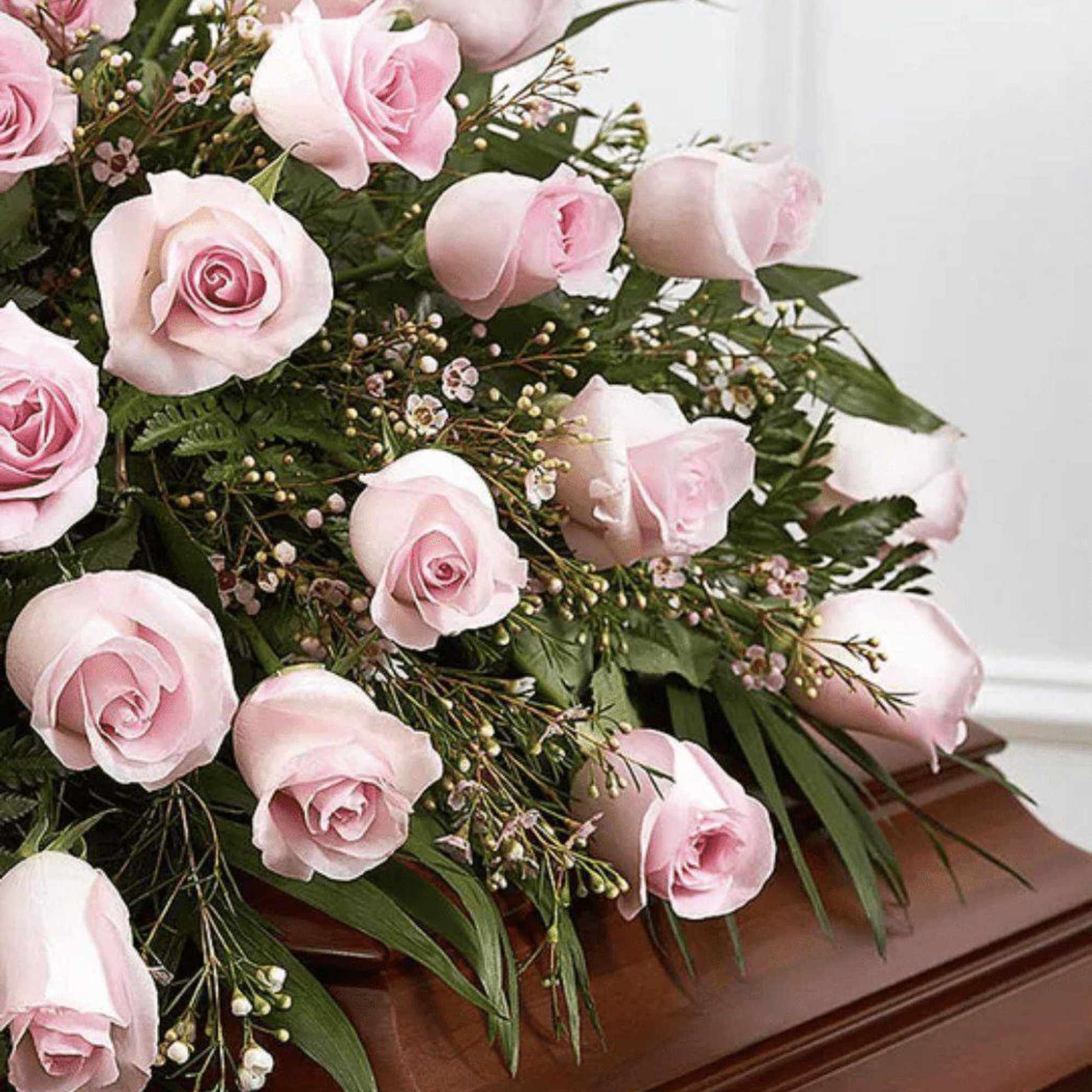 Pink roses arranged on a wooden casket