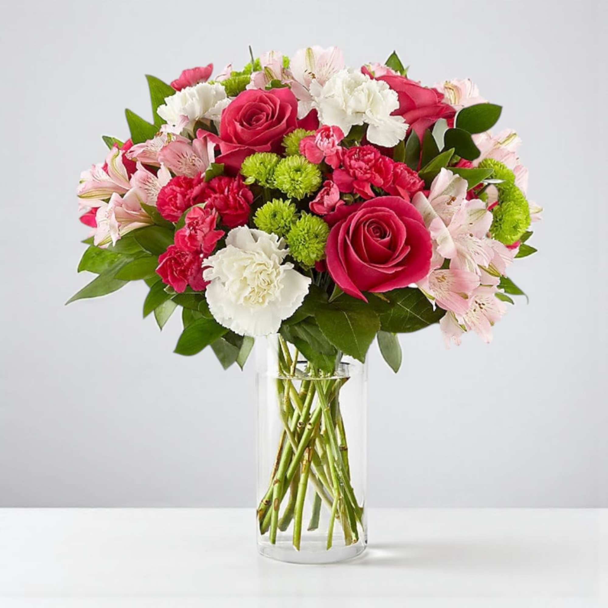Bouquet of pink and white flowers in a clear glass vase