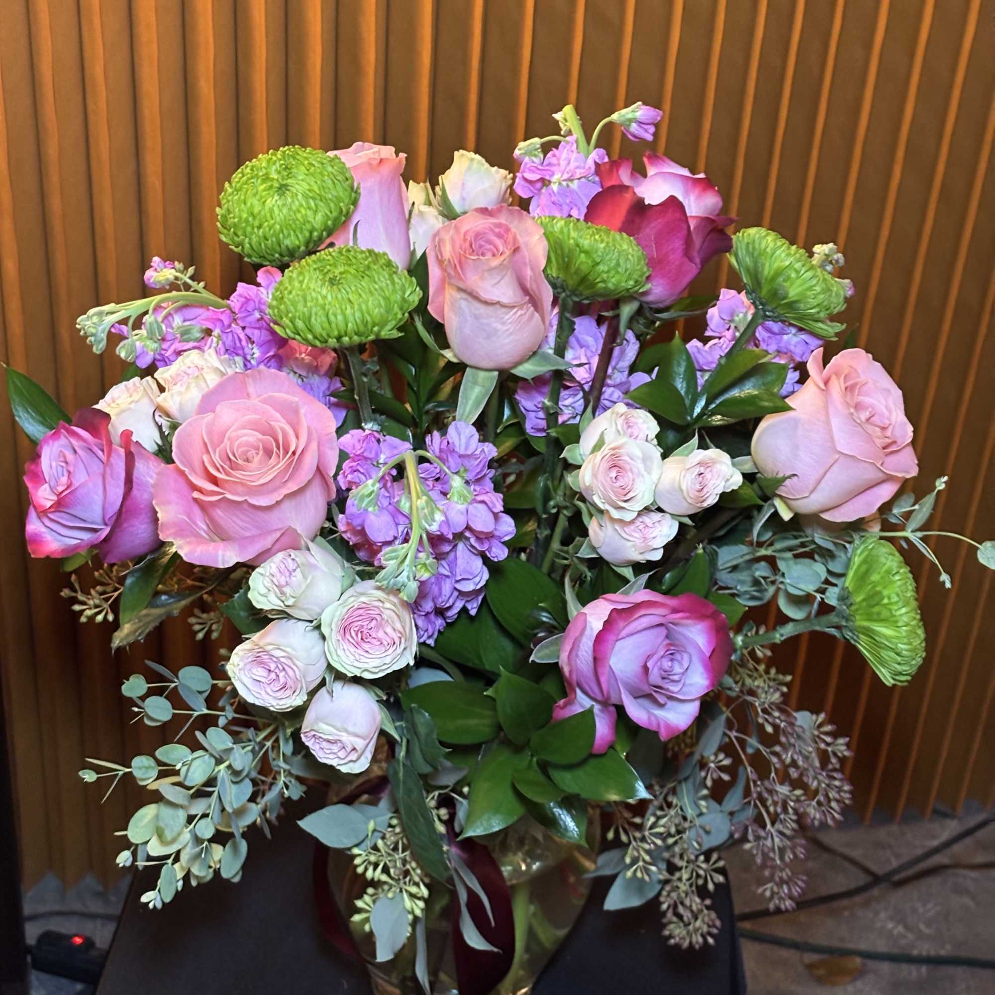 Bouquet of pink and purple roses in a glass vase