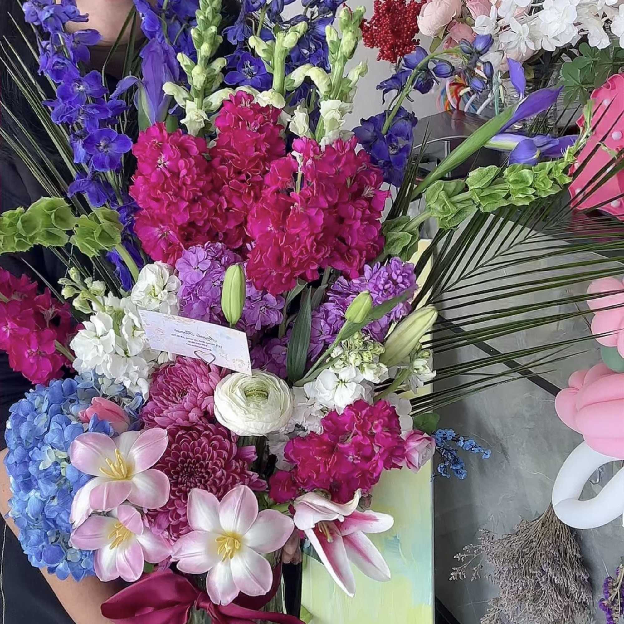 Colorful bouquet with purple, pink, white, and blue flowers