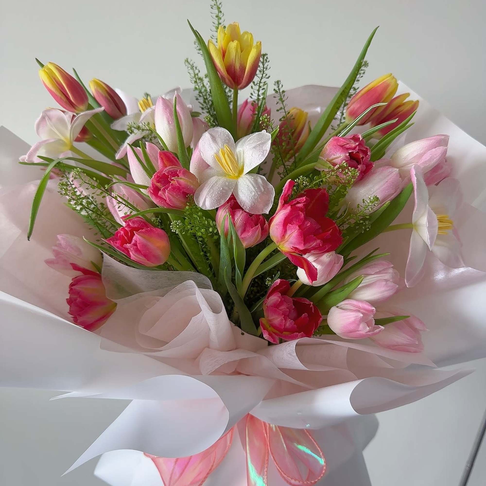Bouquet of pink and yellow tulips with white flowers in pale wrapping, photo 2 of 4