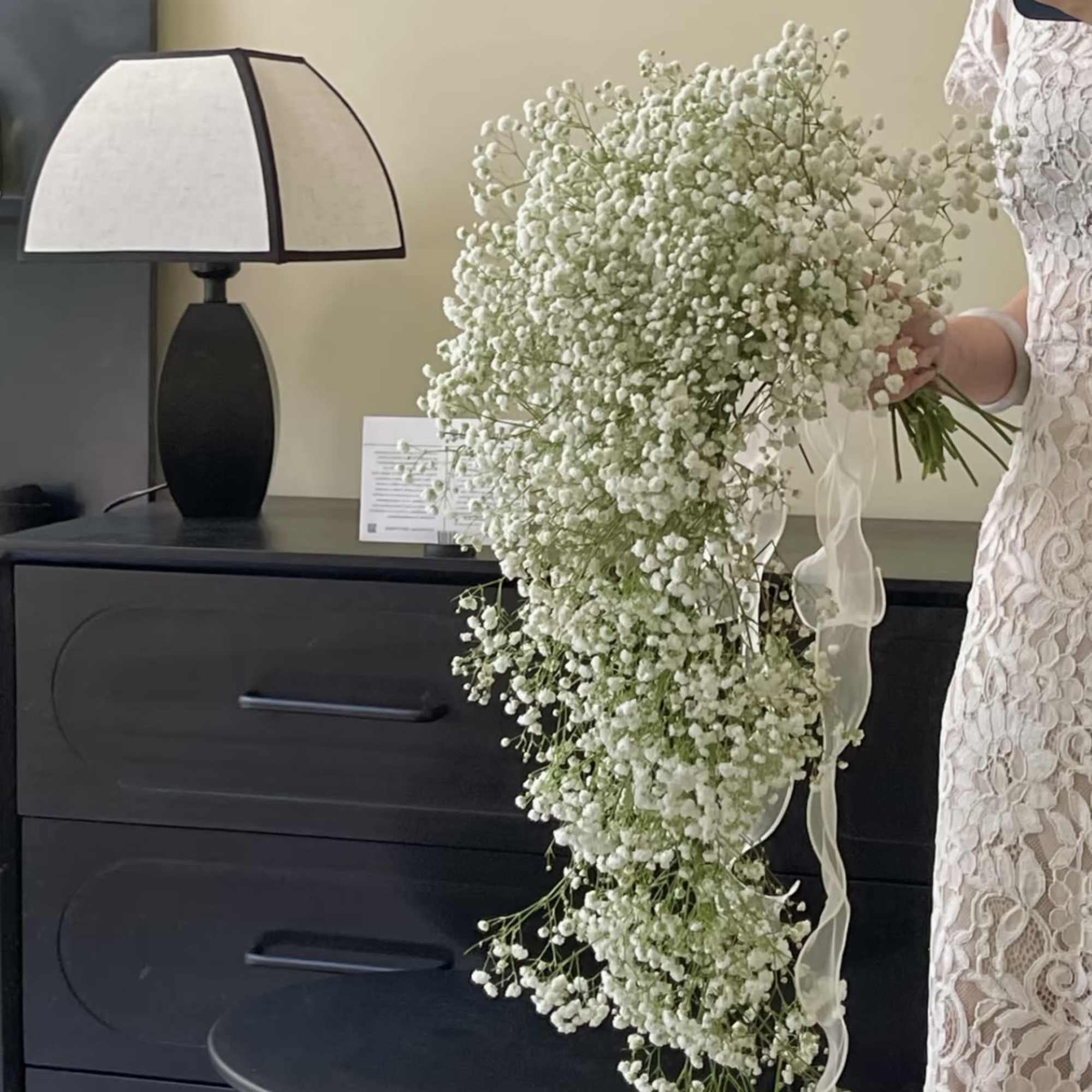 Large cascading bouquet of white baby's breath with a ribbon tie