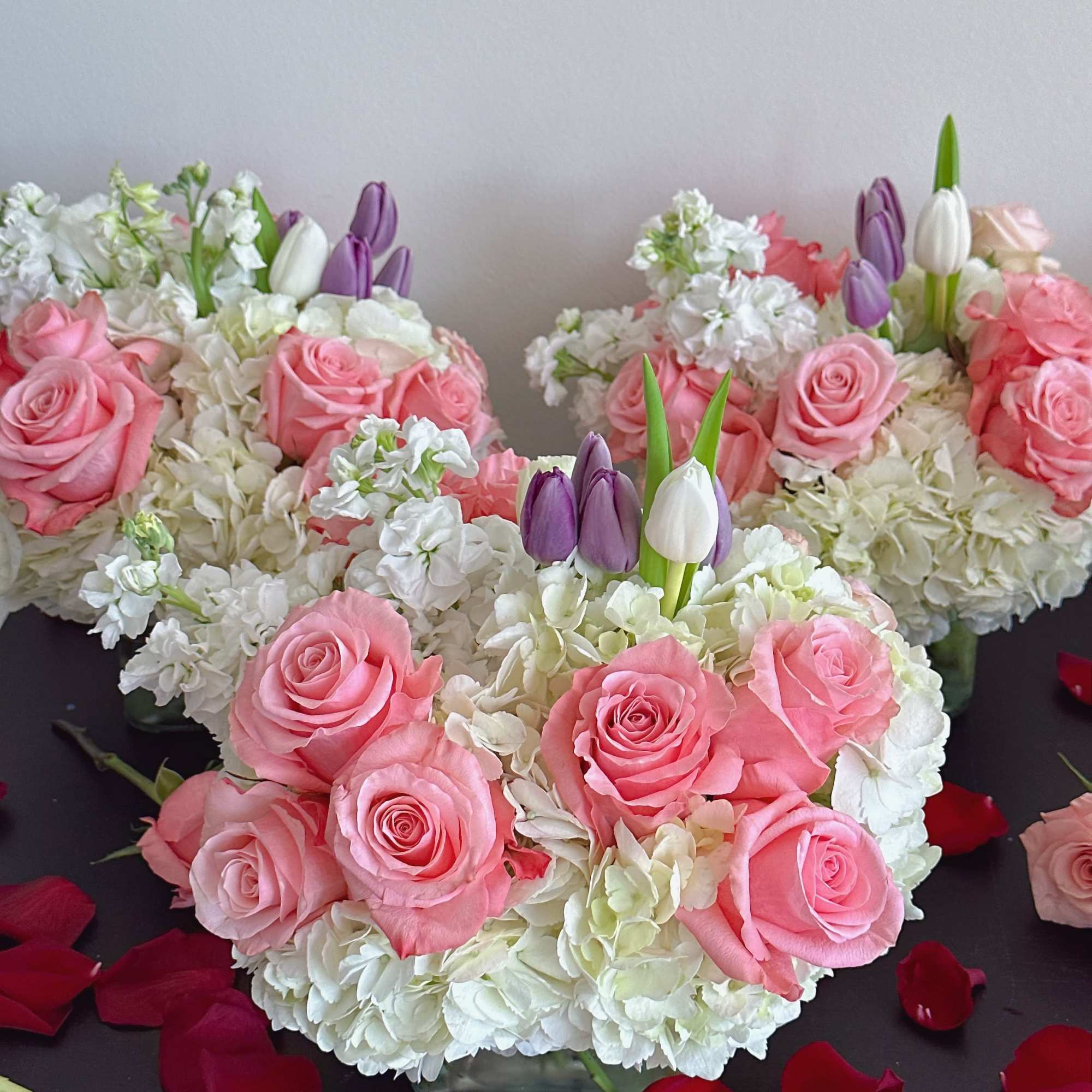 Pink roses and white hydrangeas with purple and white tulips
