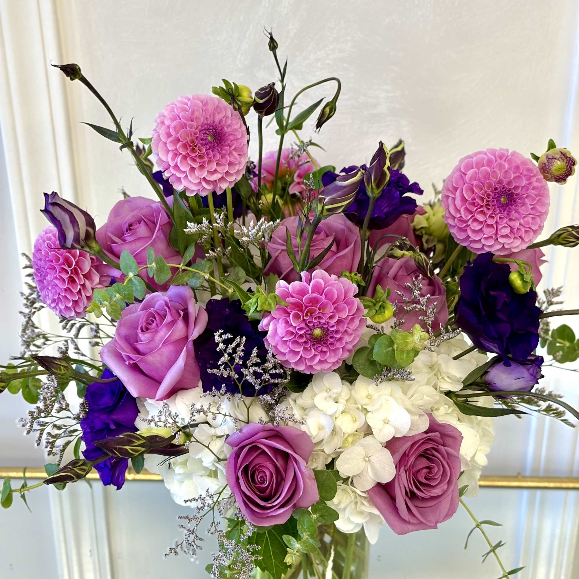 Pink and purple mixed bouquet in a clear glass vase