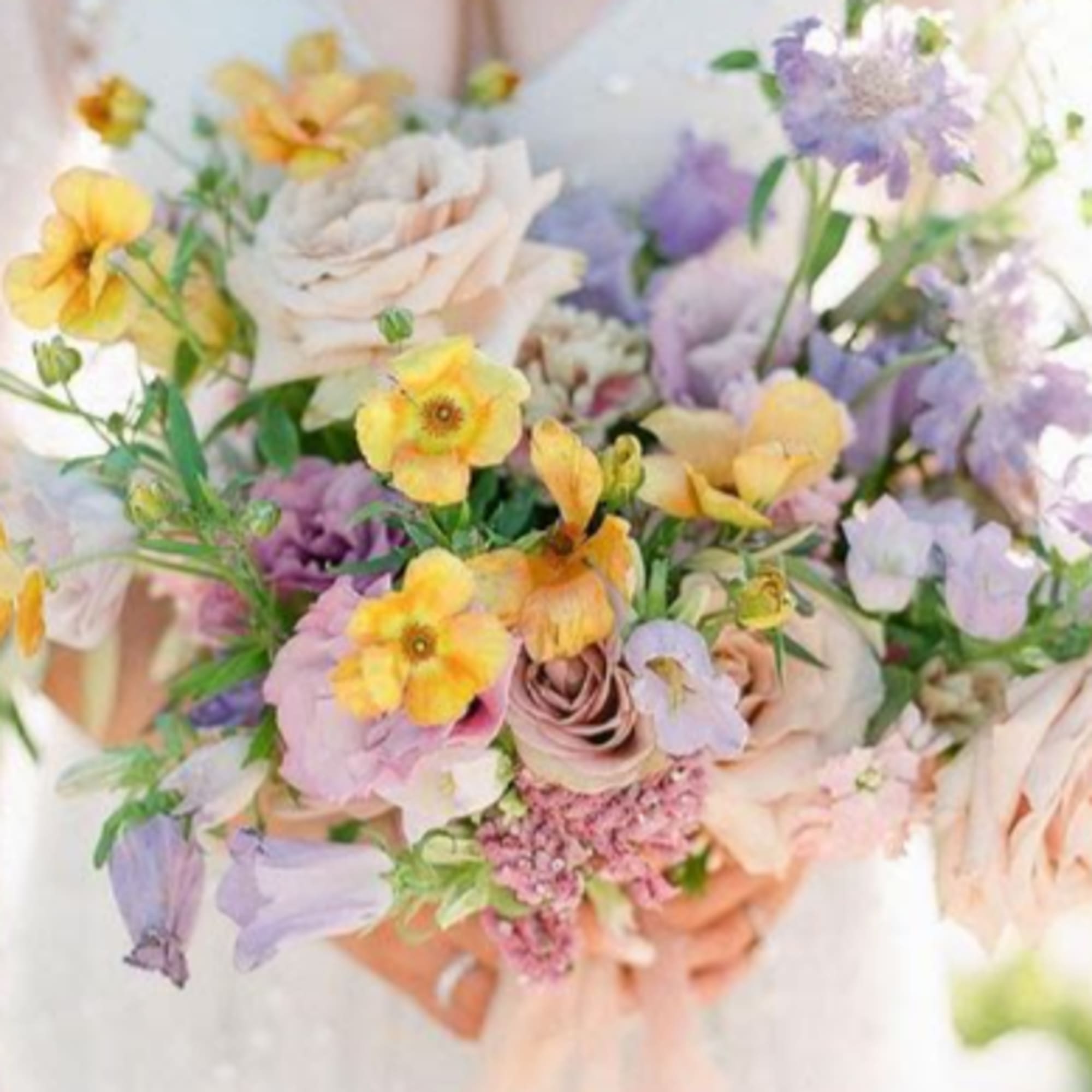 Pastel bouquet with roses and small yellow and lavender flowers