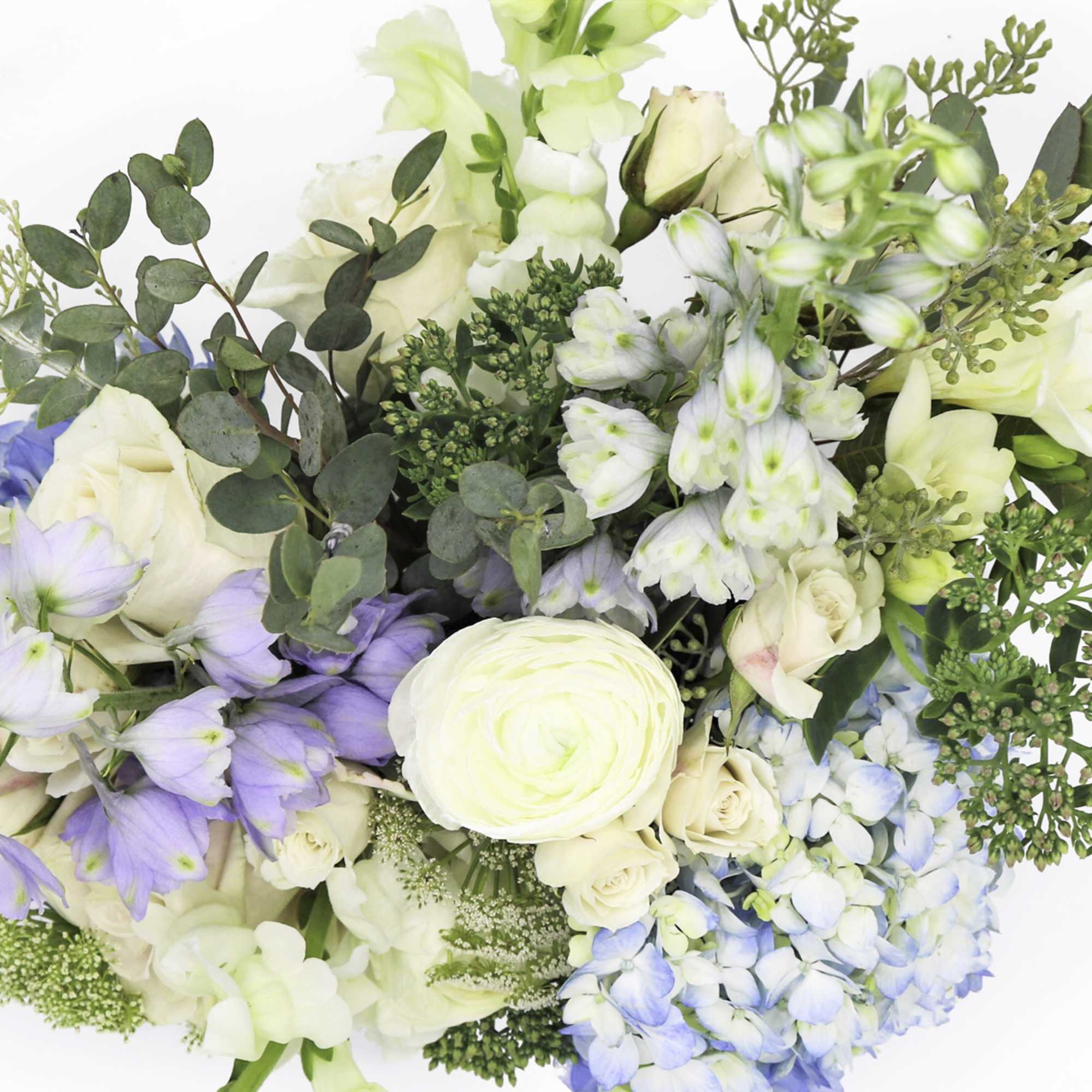 Bouquet of pale roses, blue hydrangea, and lavender flowers