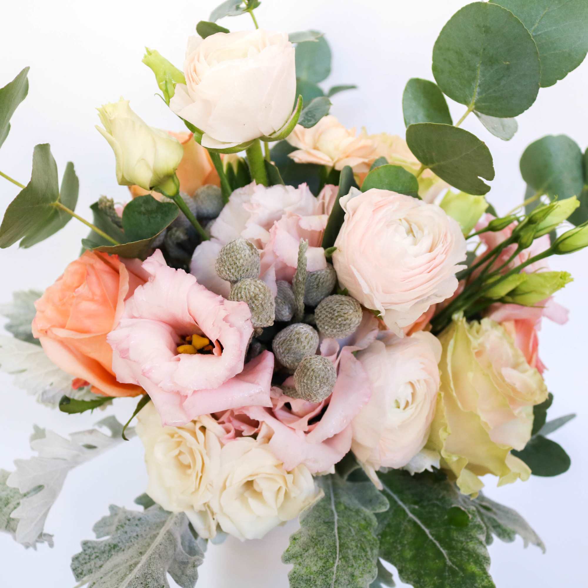 Bouquet of pale pink and cream flowers with eucalyptus