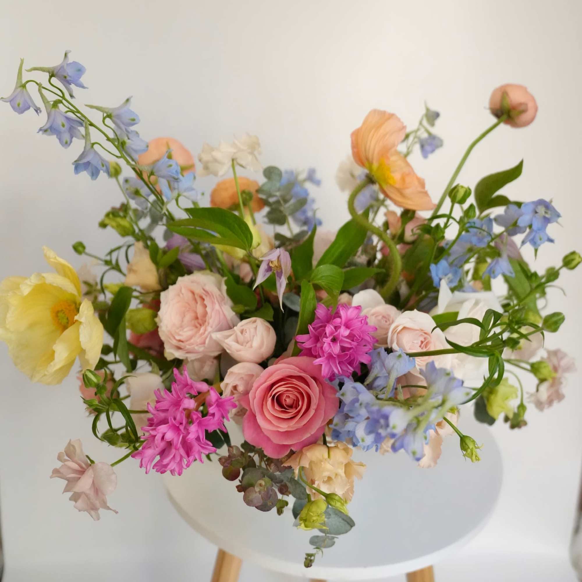An airy garden arrangement filled with soft pastel blooms and delicate movement.