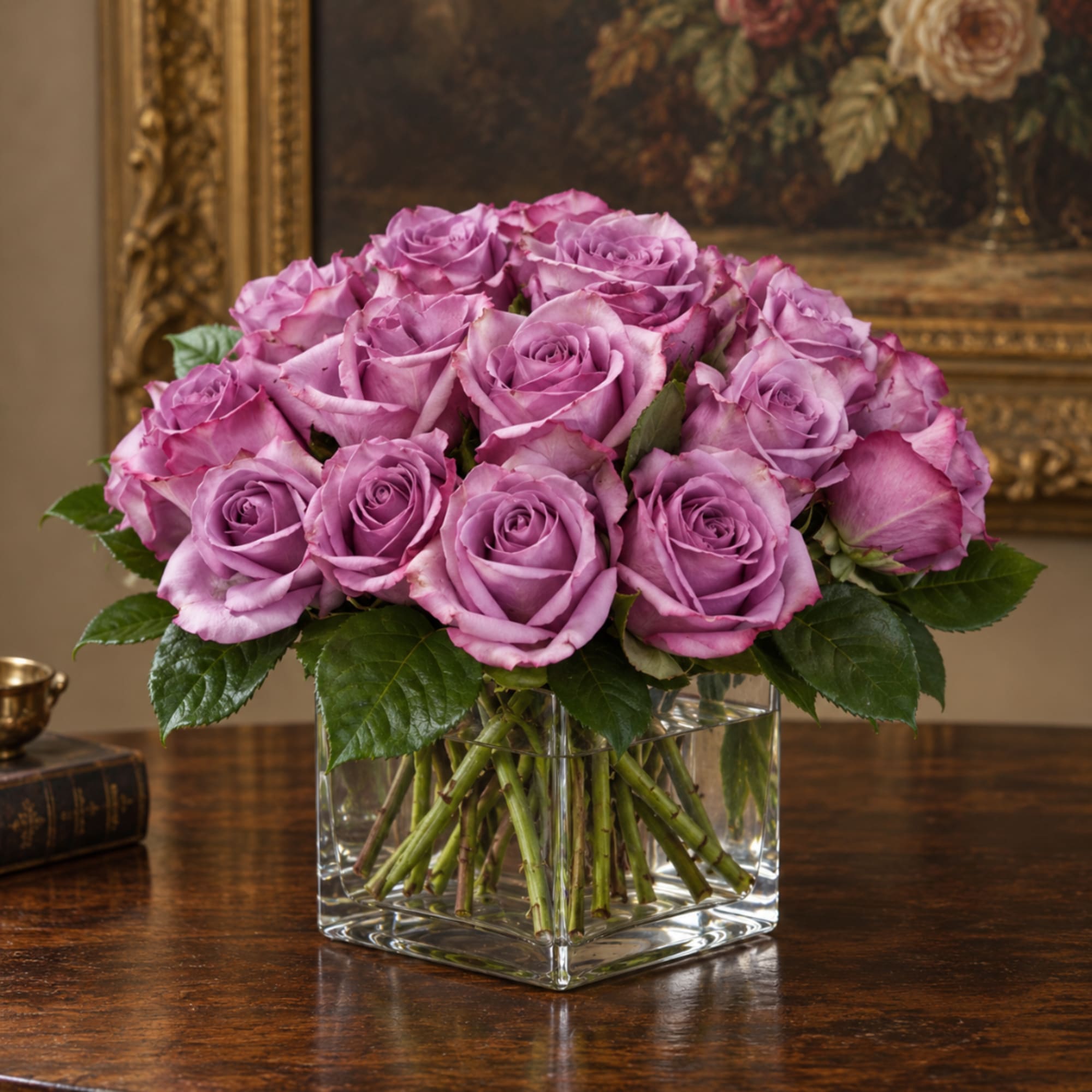 Lavender roses arranged in a clear square glass vase