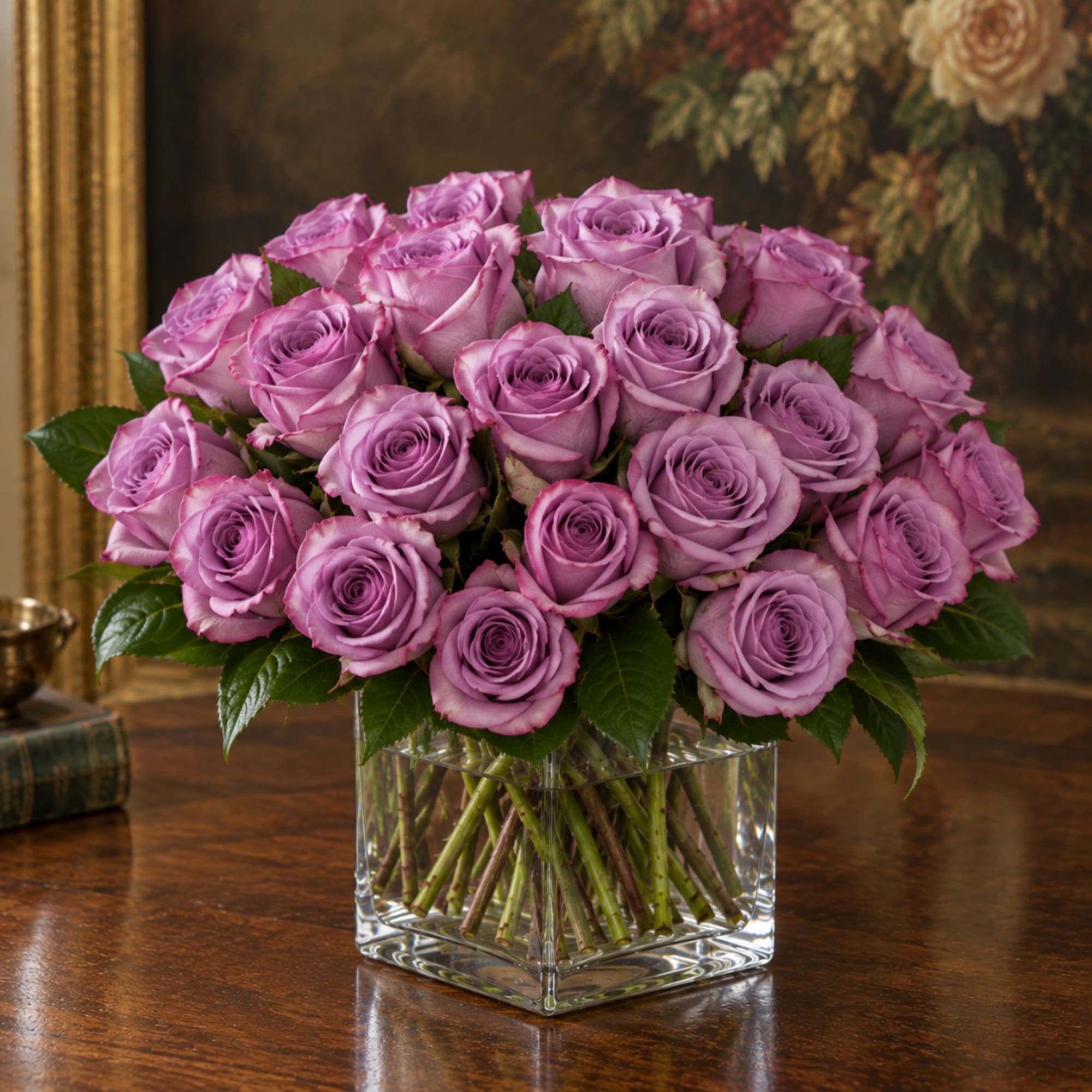 Lavender roses arranged in a clear square glass vase
