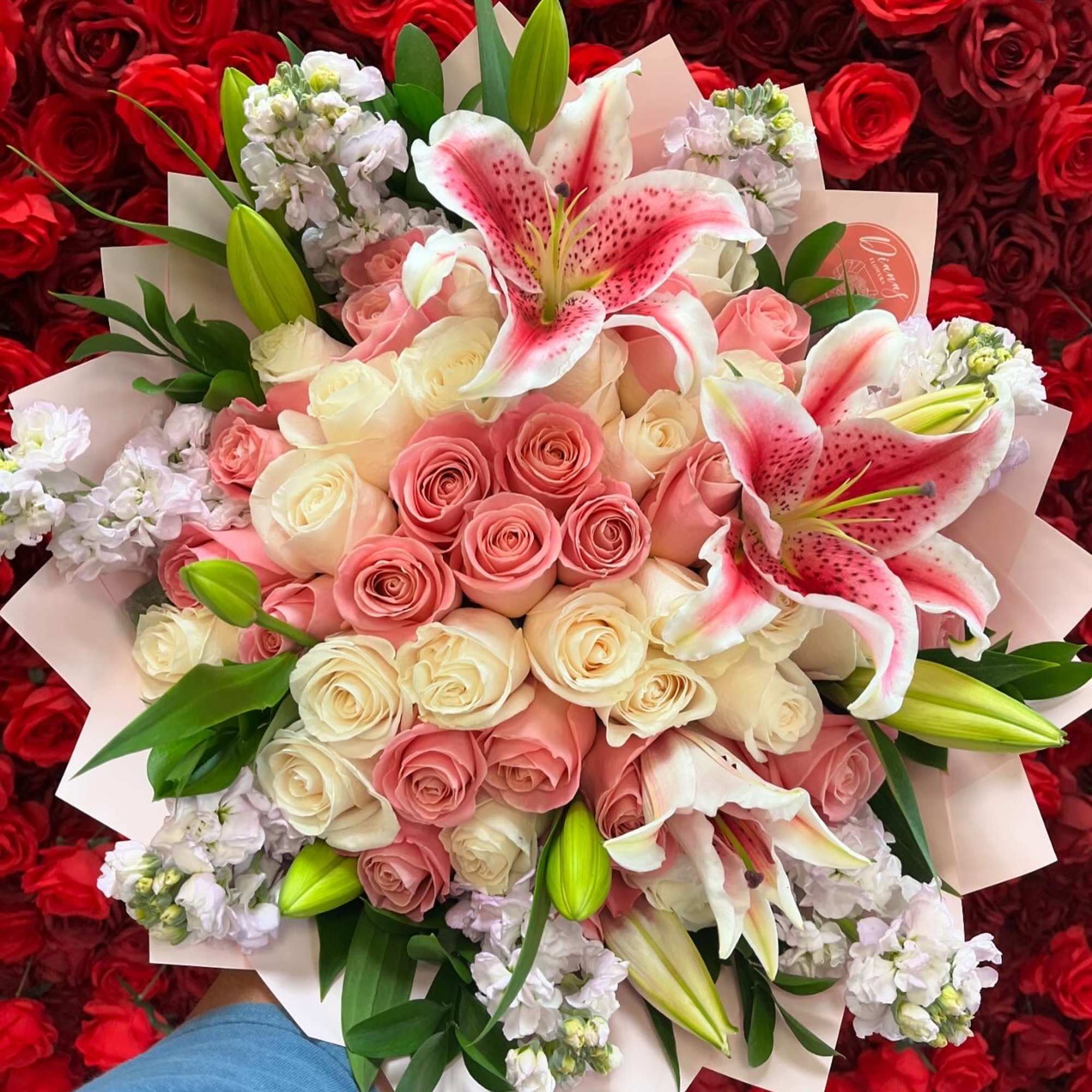 Bouquet of pink and white roses with pink lilies