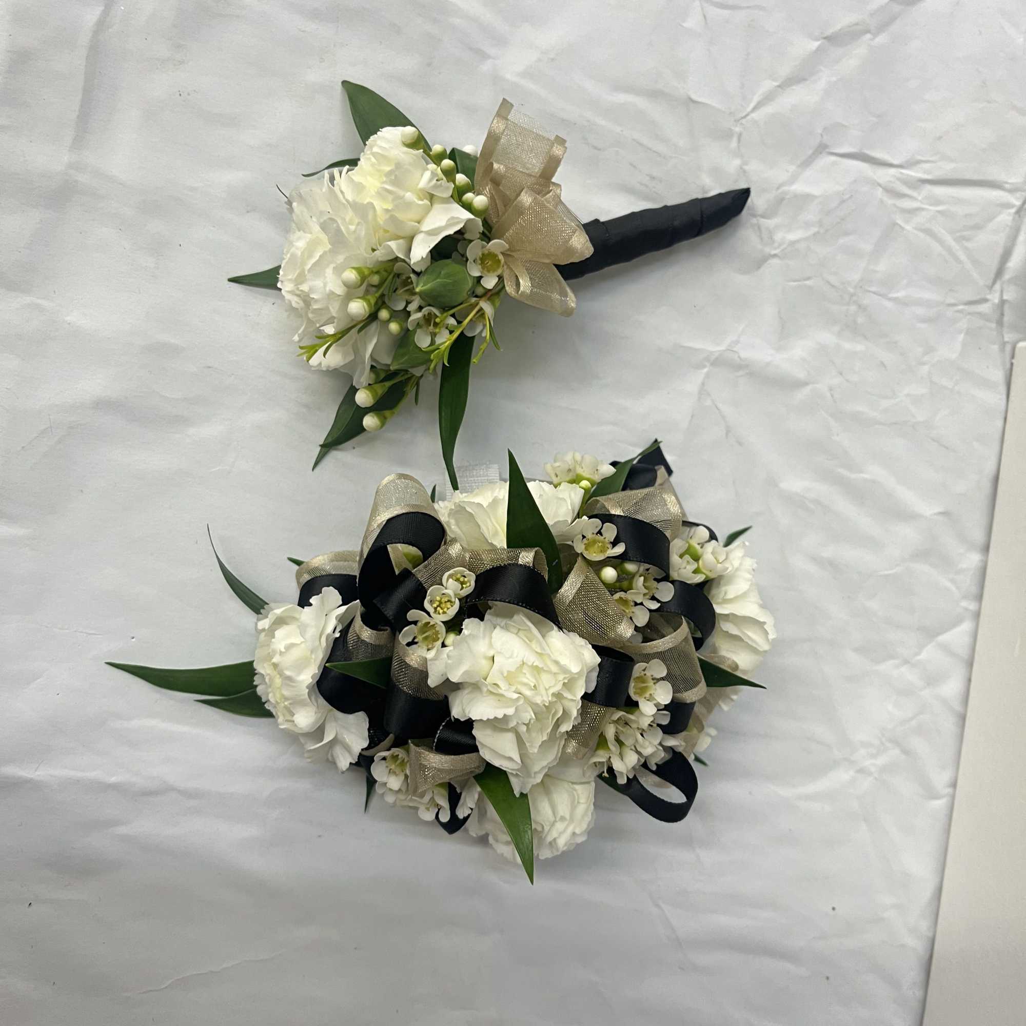 Carnation boutonniere and corsage set accented with wax flower and greenery. The, photo 2 of 2