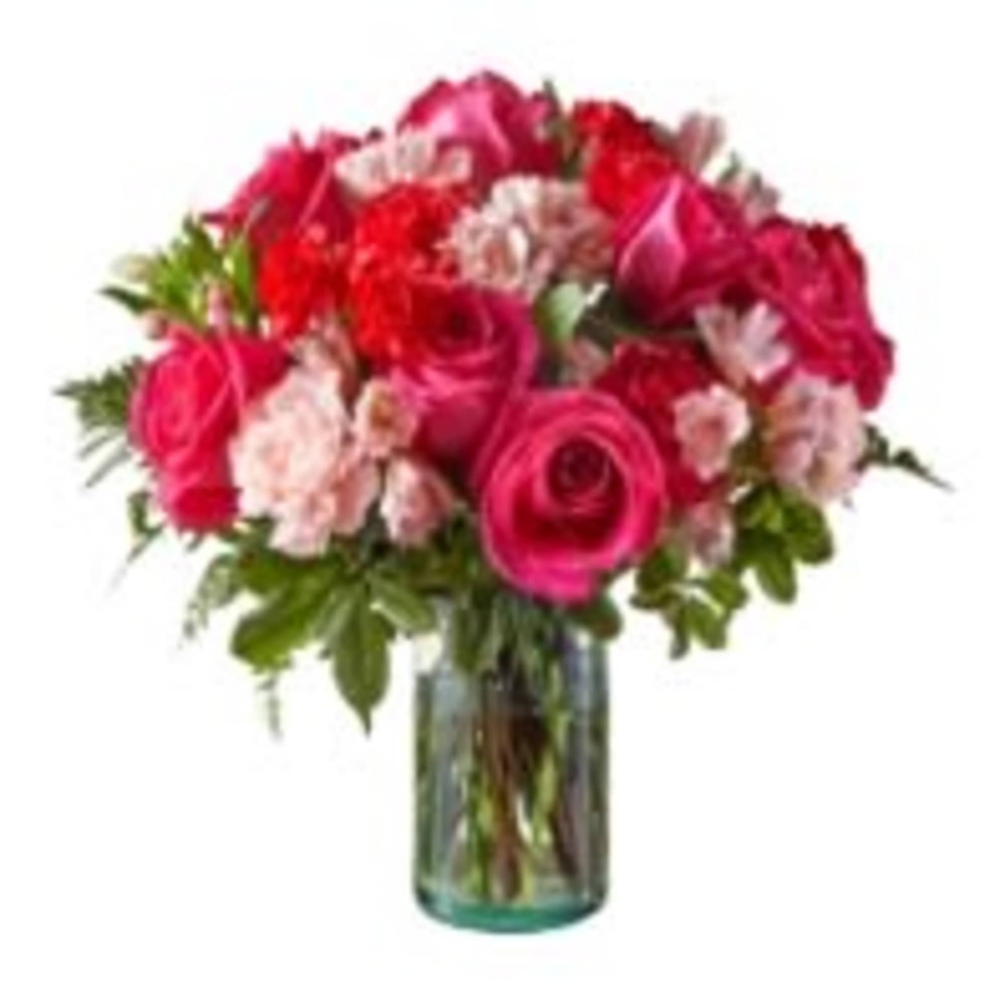 Pink and red rose bouquet with carnations in a glass vase