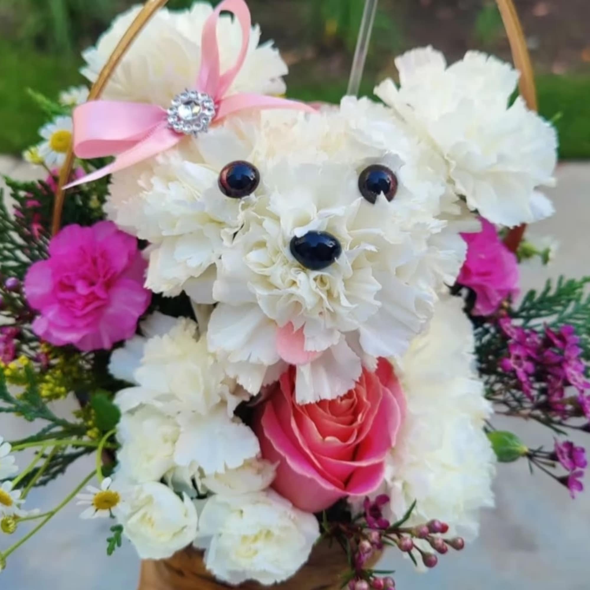 White floral teddy bear with a pink rose and ribbon bow