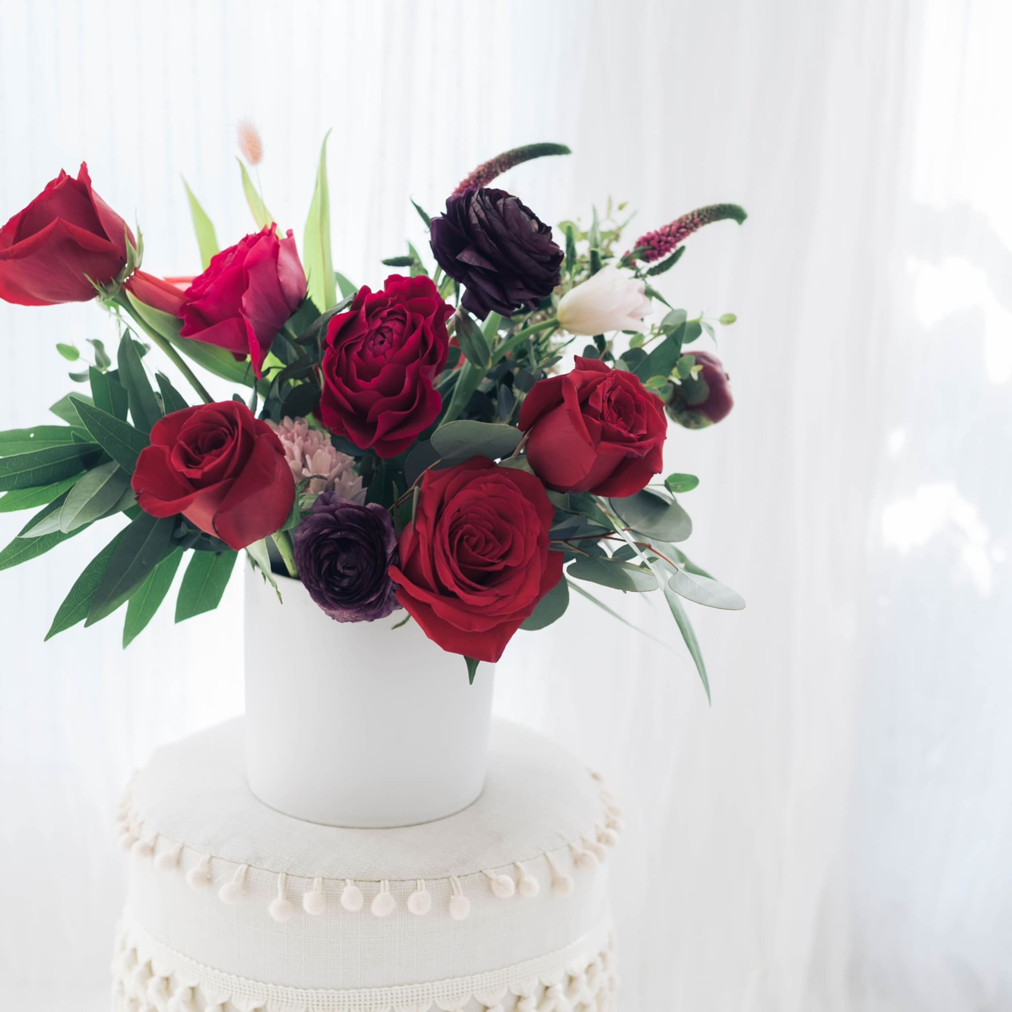 Red rose bouquet in a white vase