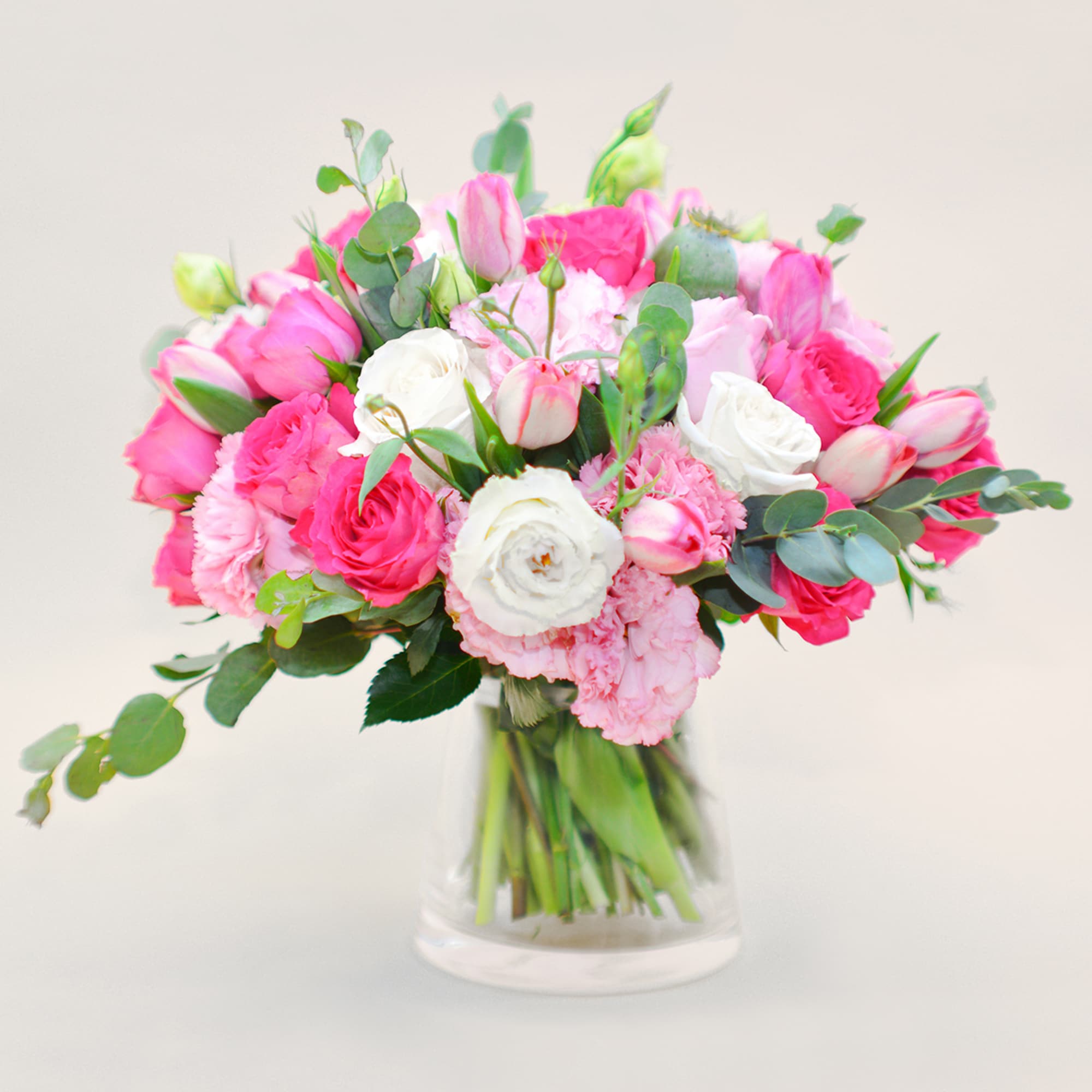 Pink and white mixed bouquet in a clear glass vase