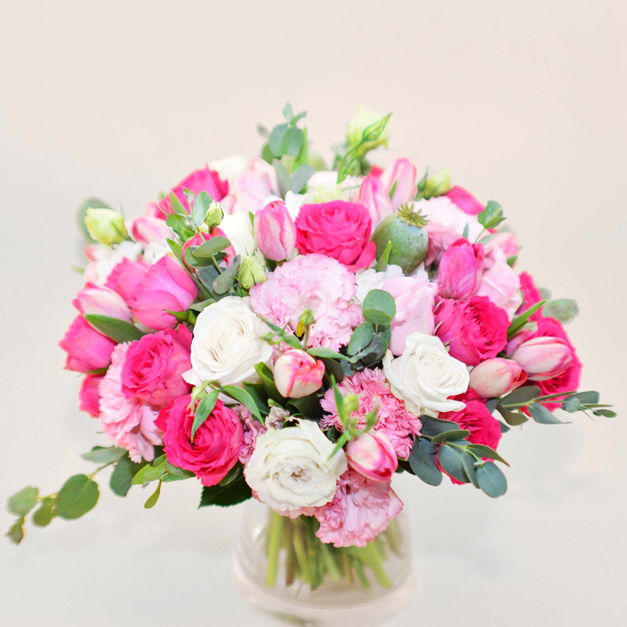 Pink and white bouquet in a clear glass vase