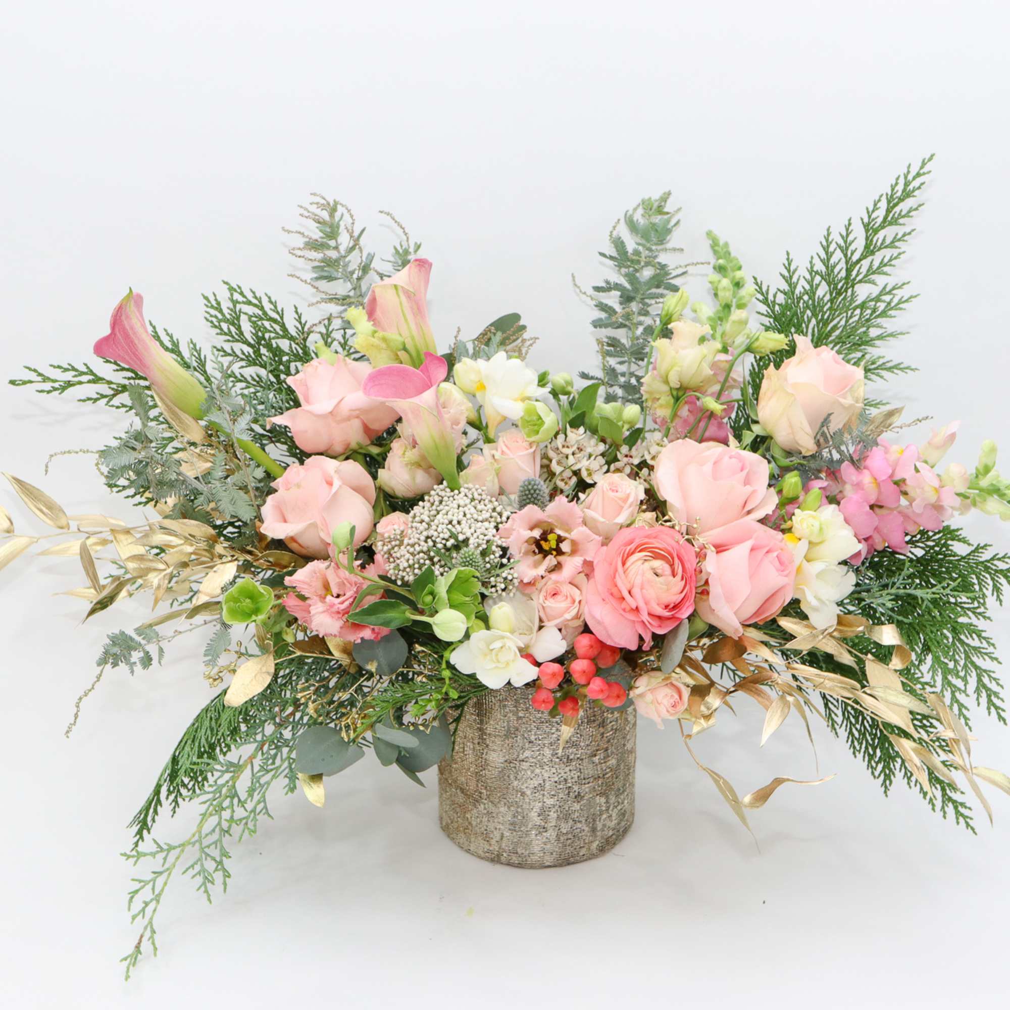 Pink and cream floral arrangement in a textured vase