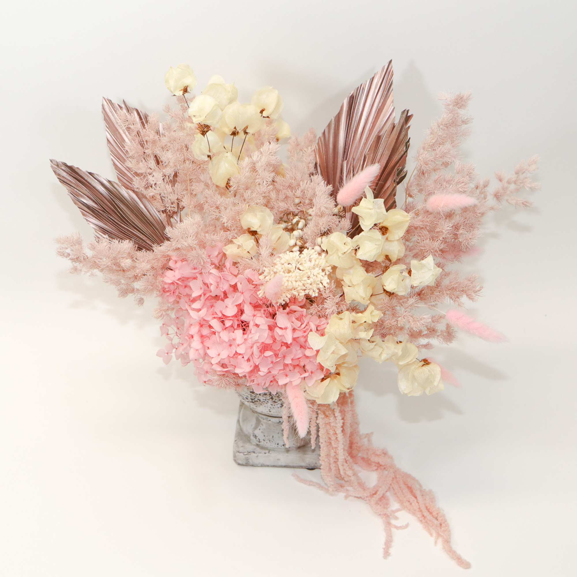 Pink and cream dried floral arrangement in a gray vase