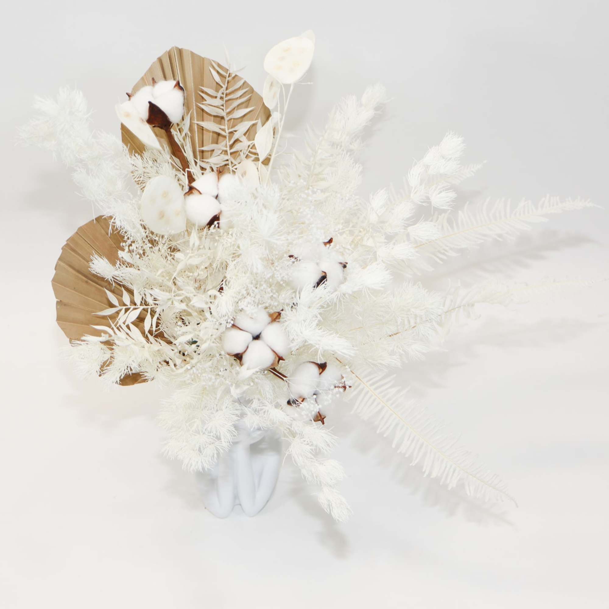 White dried floral arrangement with cotton stems and beige fan-shaped accents
