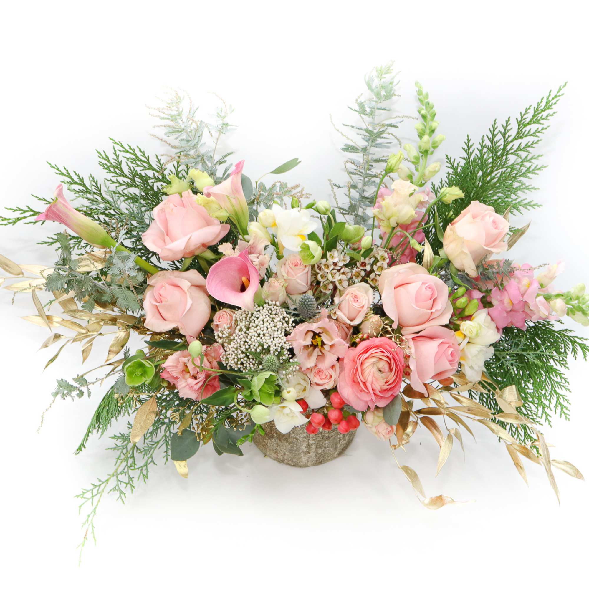 Pink rose and calla lily arrangement in a low stone container
