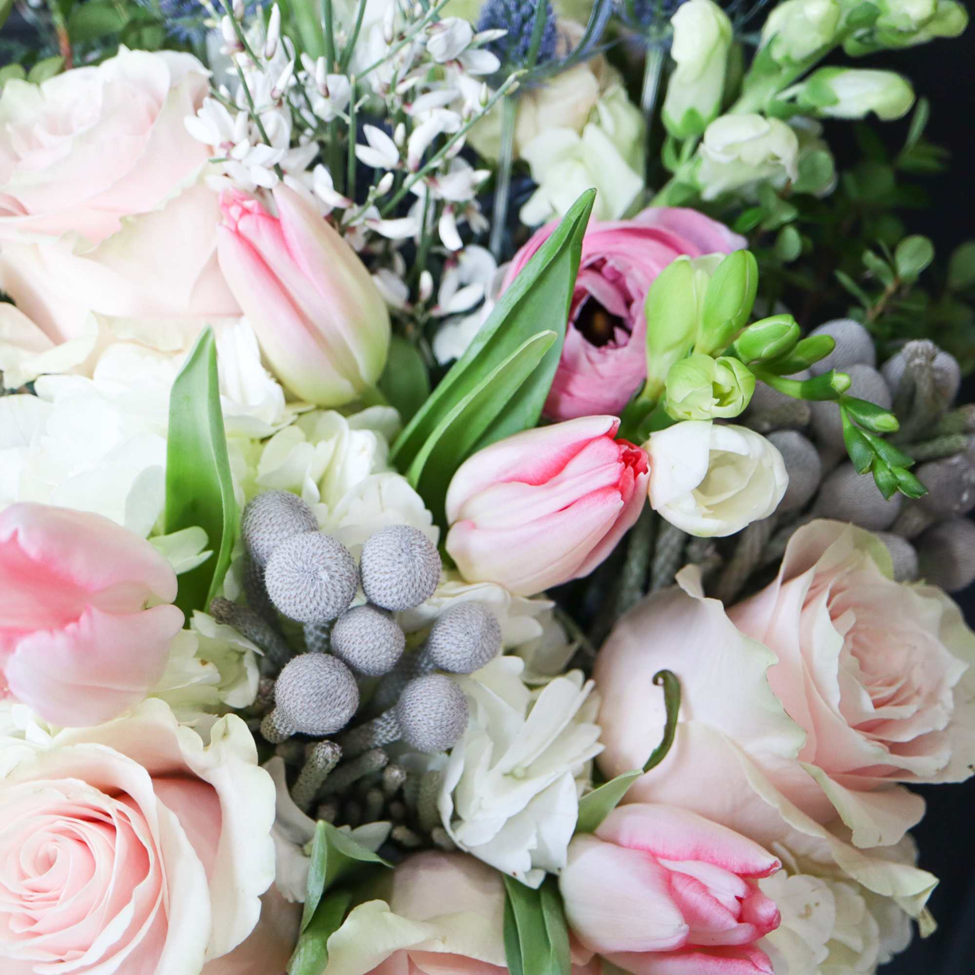 Bouquet of pale pink roses and tulips with white flowers