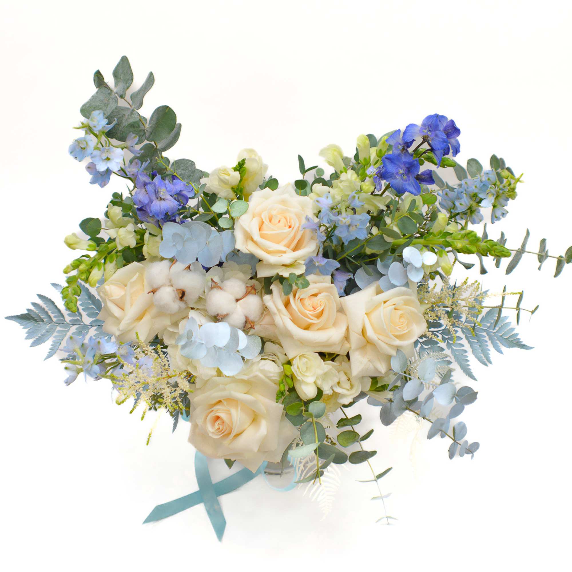 Bouquet of cream roses and blue flowers with eucalyptus
