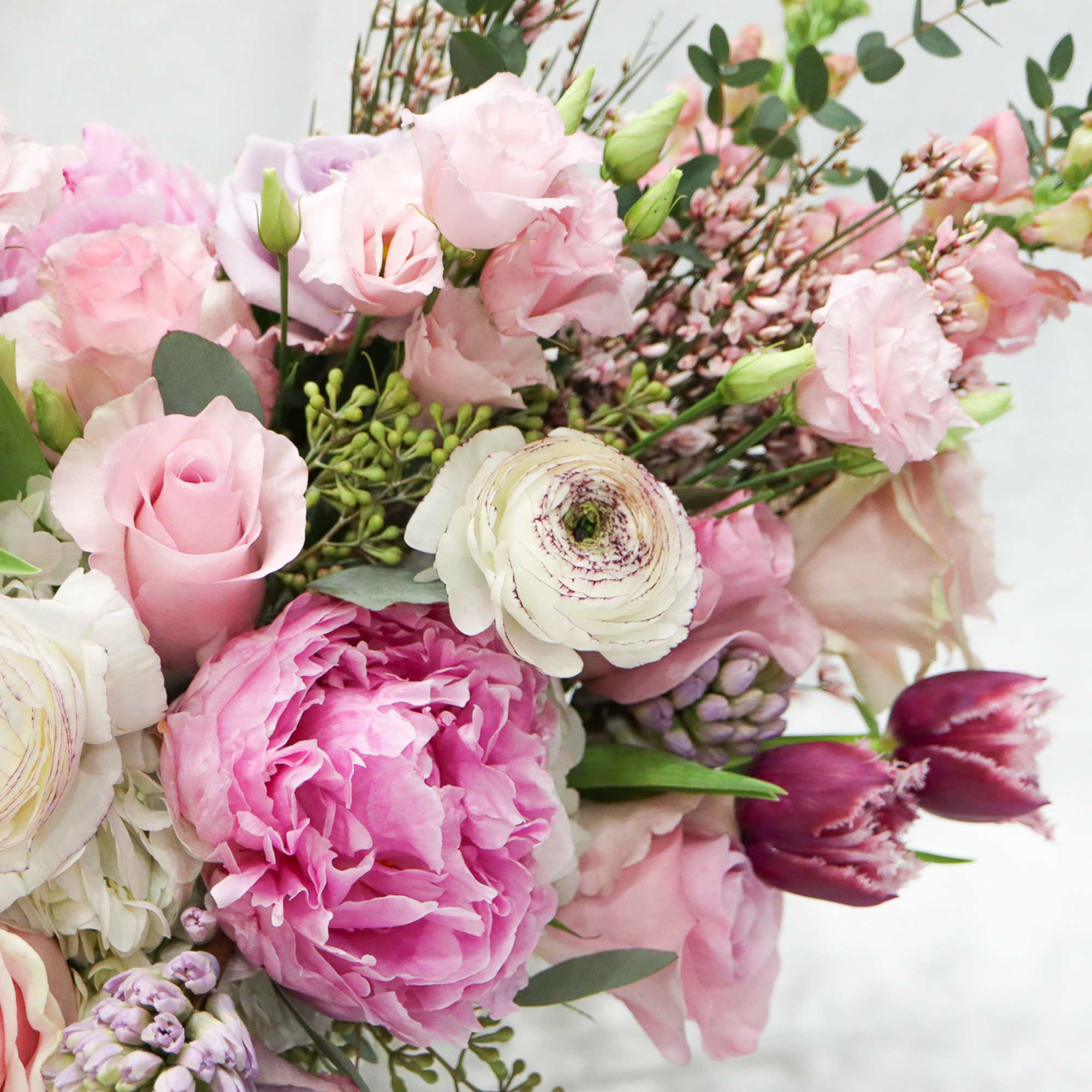 Pink and white mixed bouquet with roses, peonies, and ranunculus
