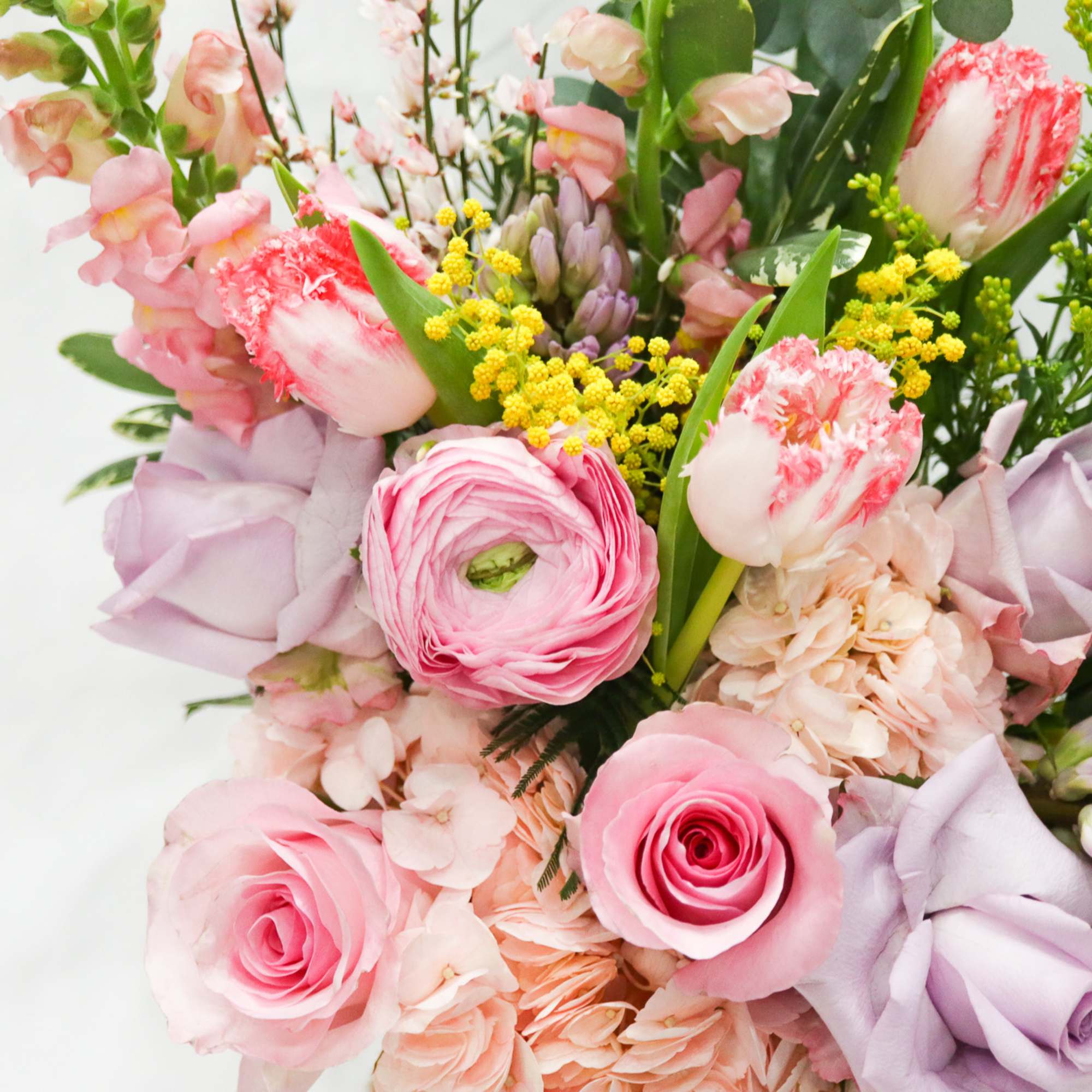 Bouquet of pink and lavender flowers with yellow accents
