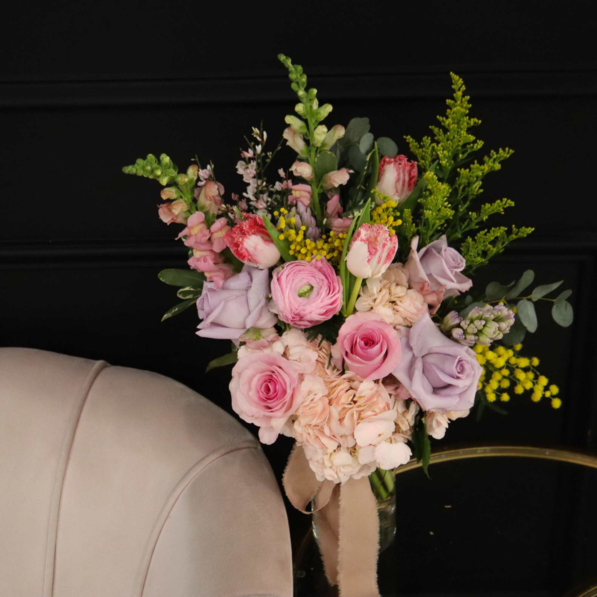 Bouquet of pink and lavender flowers in a glass vase