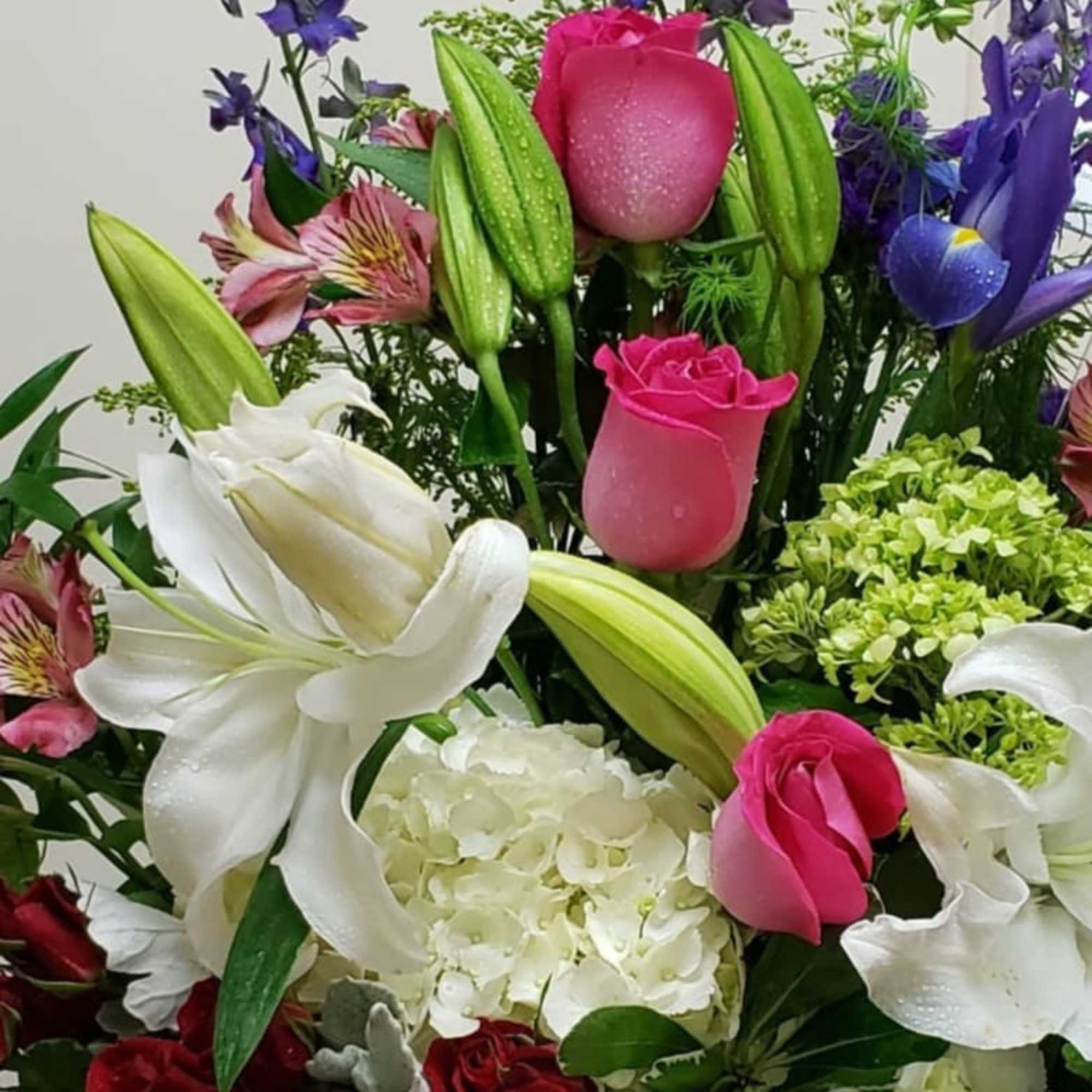 Mixed bouquet with pink and white roses, lilies, and purple flowers