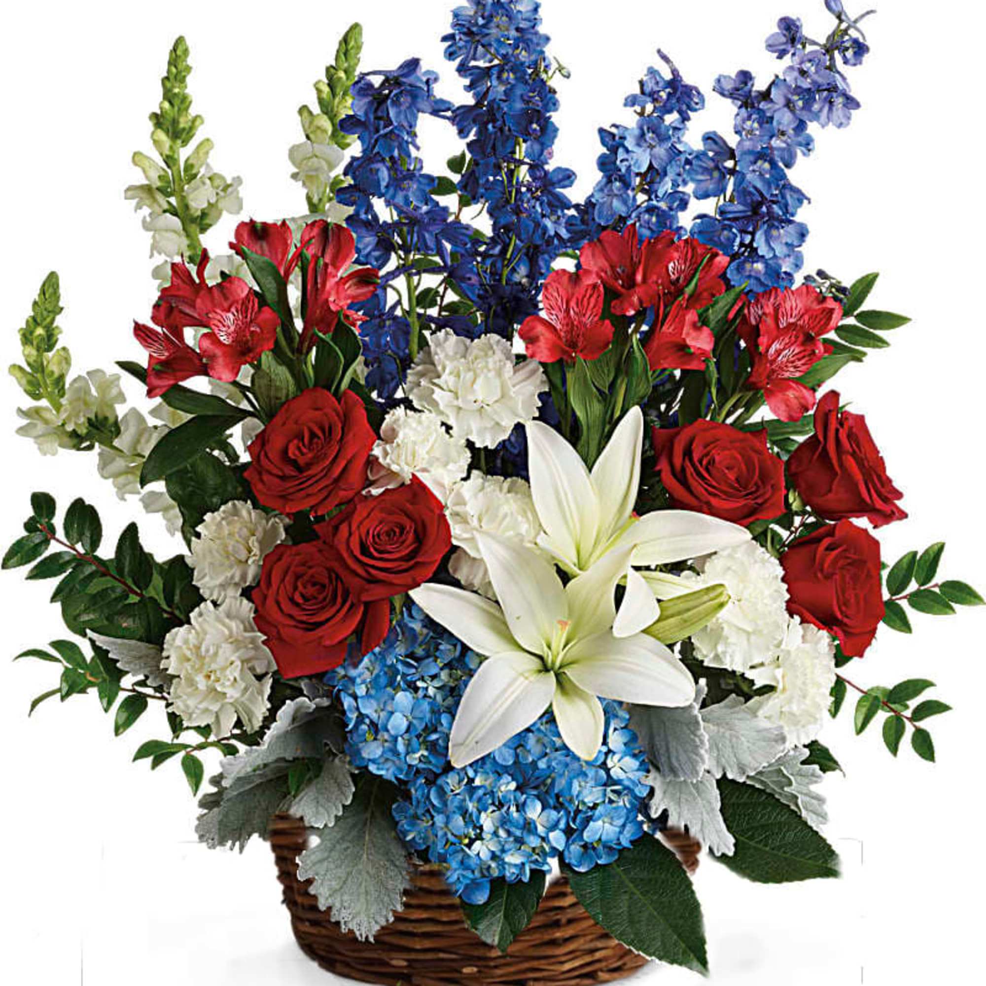 Patriotic basket arrangement with red roses, white lilies and carnations, and blue delphinium and hydrangea.