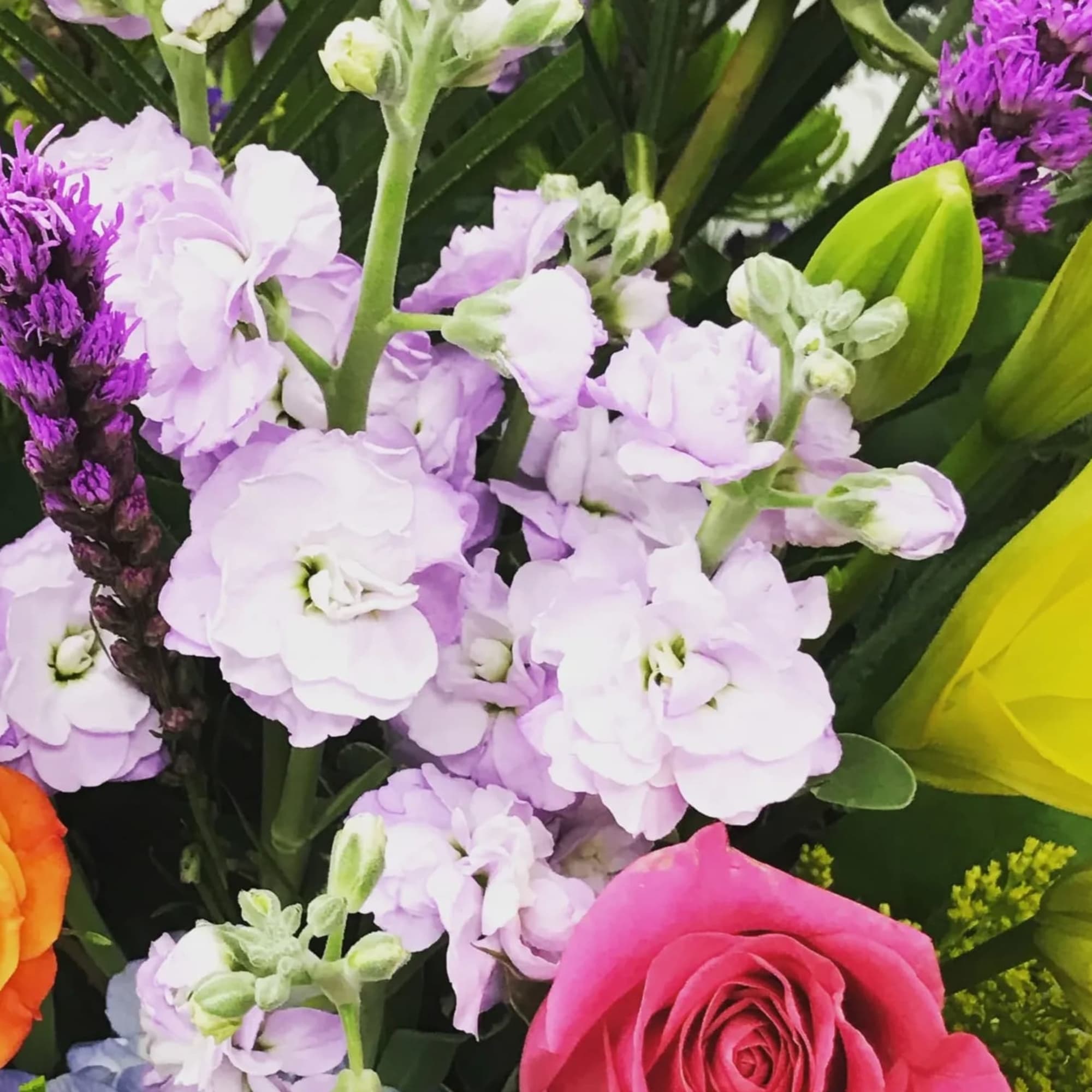 Colorful bouquet with pink roses, lavender flowers, and yellow lilies