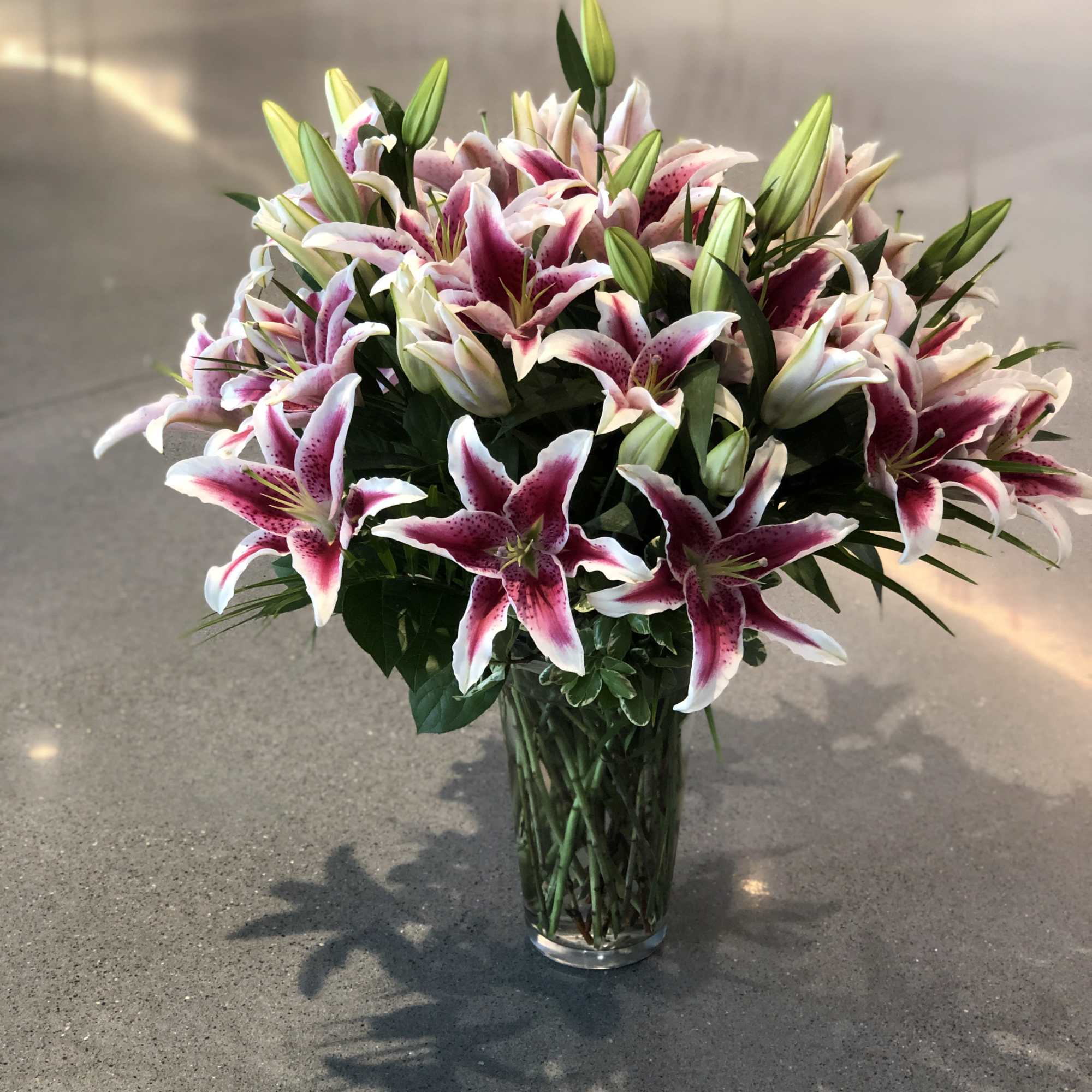 Bouquet of pink and white lilies in a clear glass vase, photo 14 of 16