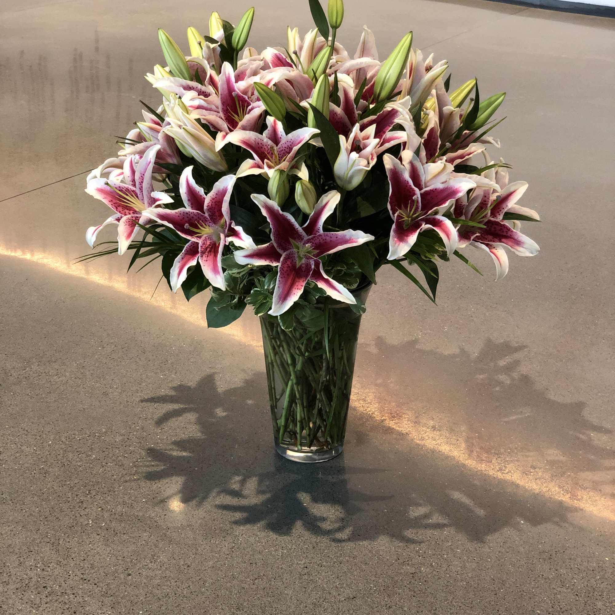 Bouquet of pink and white lilies in a clear glass vase, photo 16 of 16