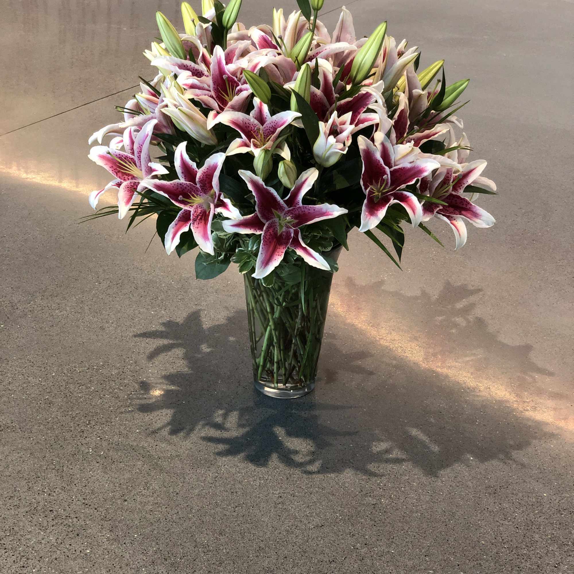 Bouquet of pink and white lilies in a clear glass vase, photo 6 of 16