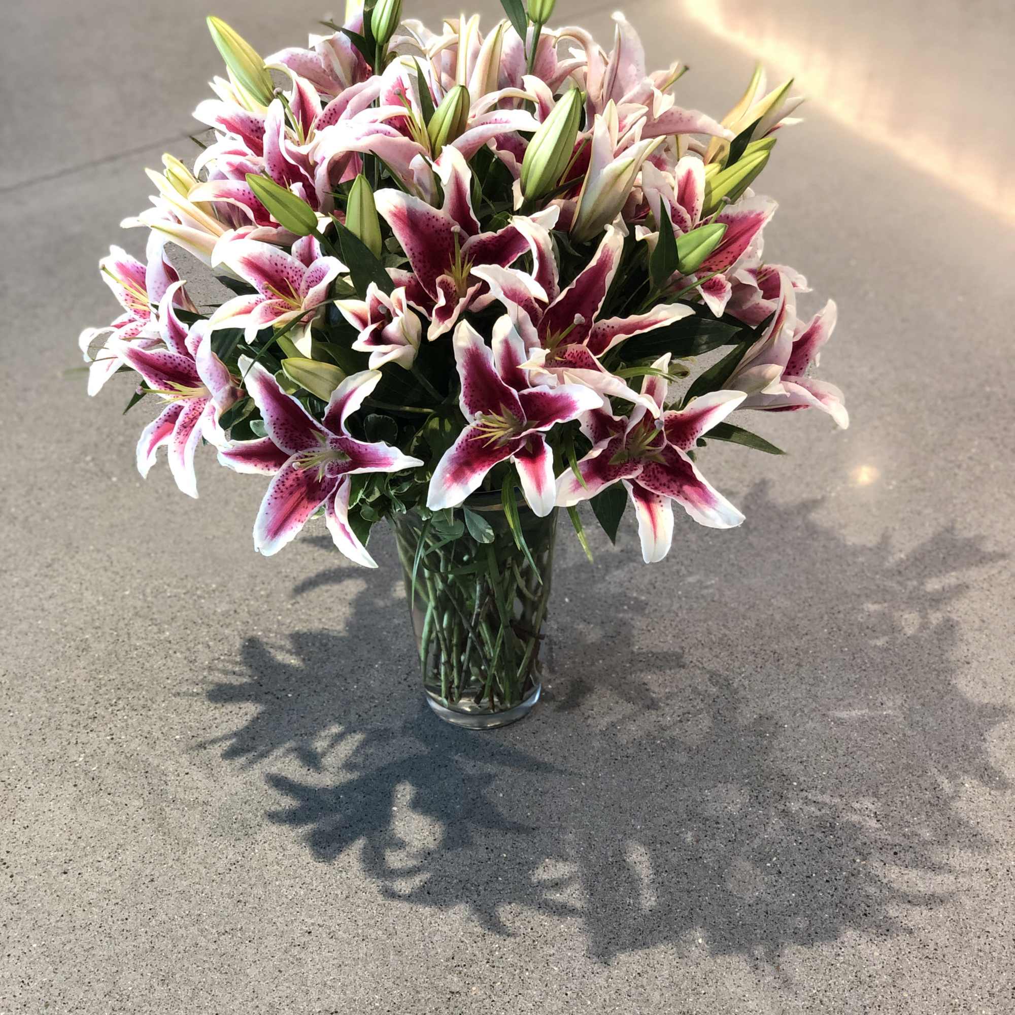 Bouquet of pink and white lilies in a clear glass vase, photo 9 of 16