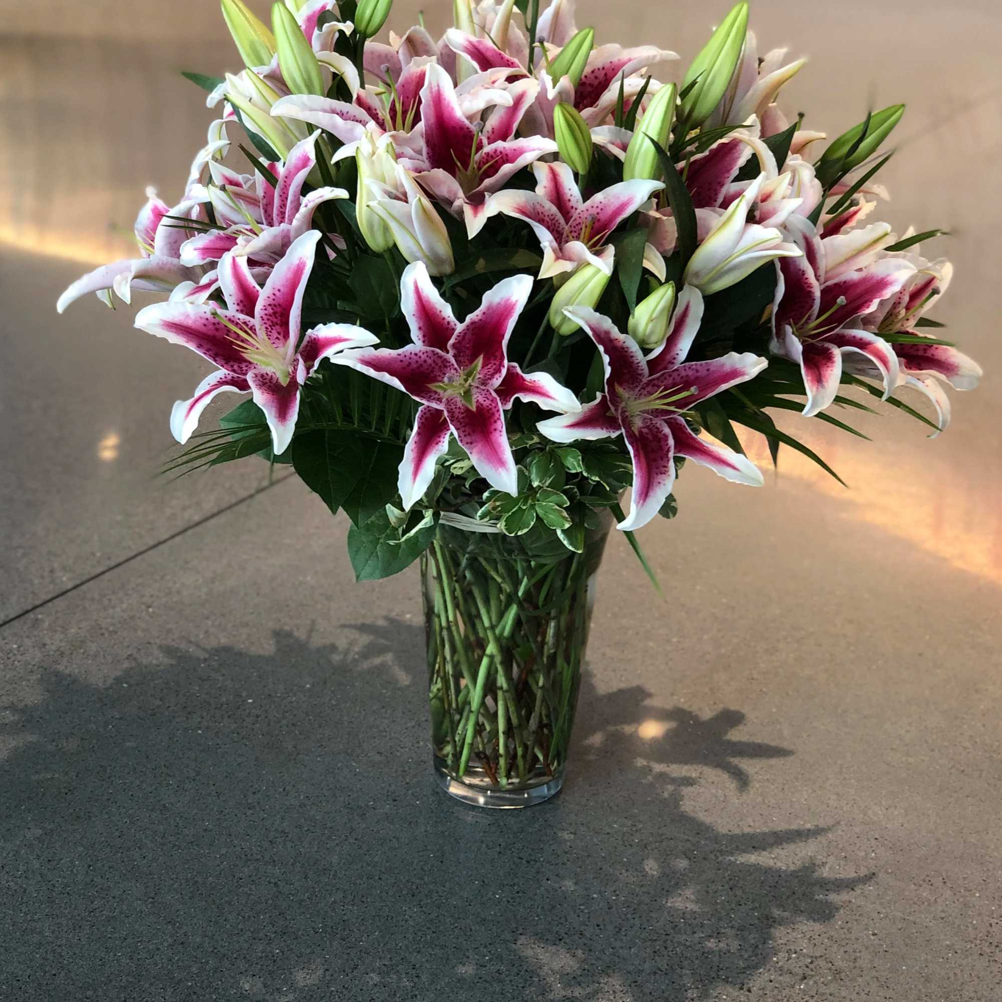 Bouquet of pink-and-white lilies in a clear glass vase, photo 4 of 16