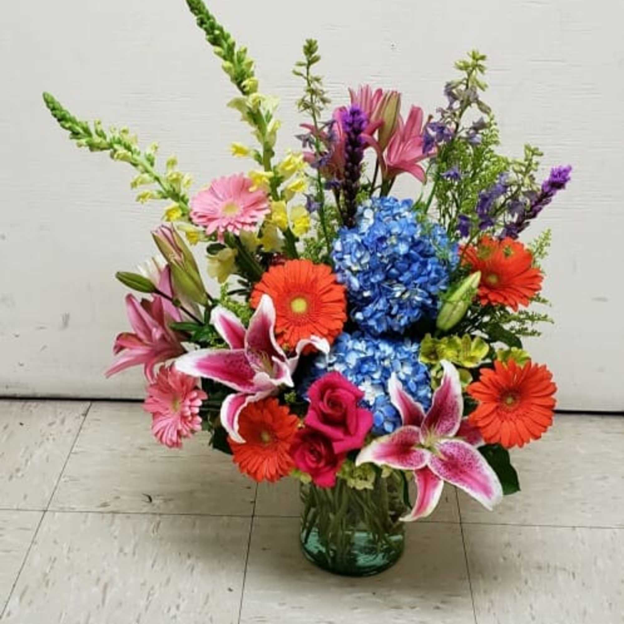 Colorful mixed flower arrangement in a glass vase