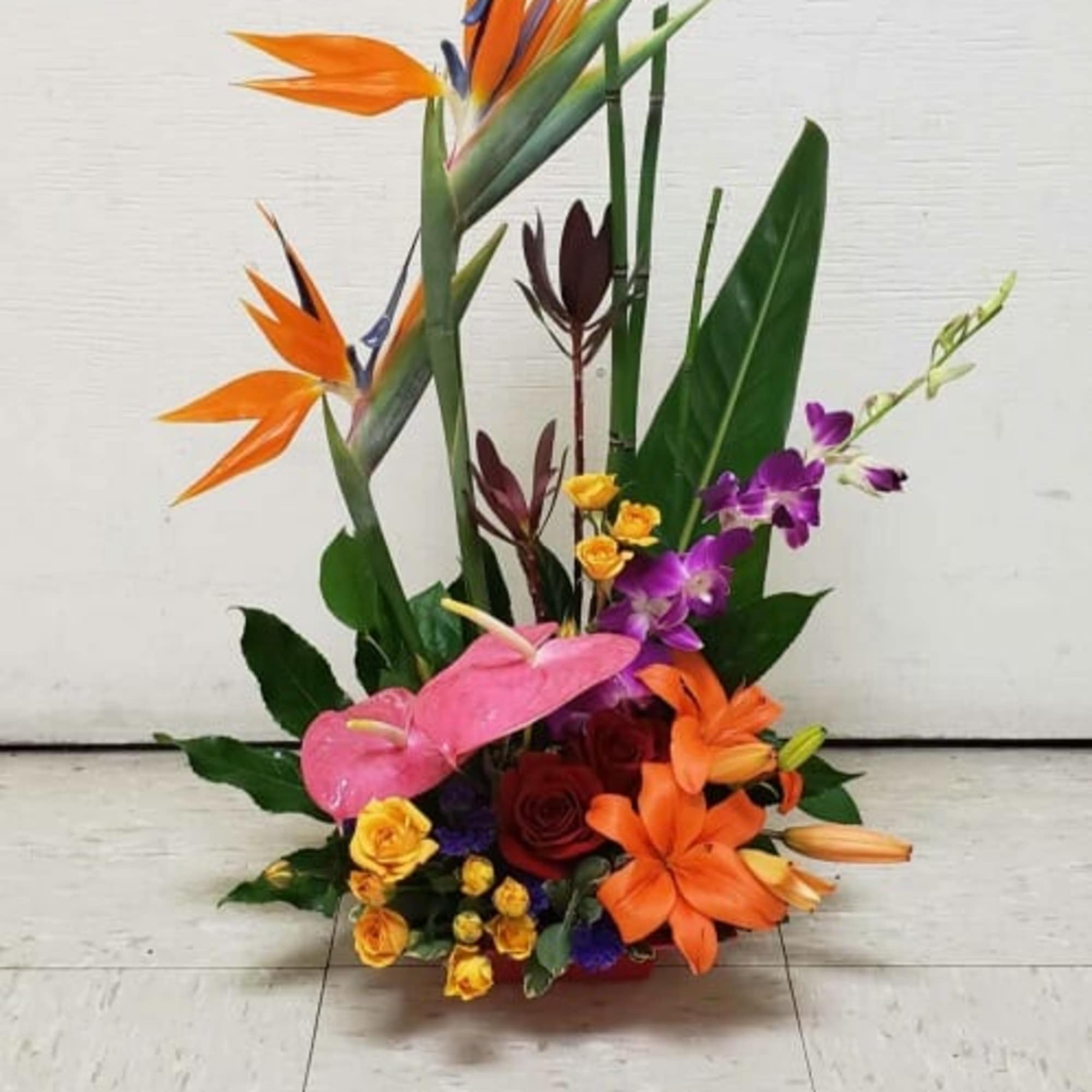 Tropical flower arrangement with orange bird-of-paradise and orchids, photo 2 of 2