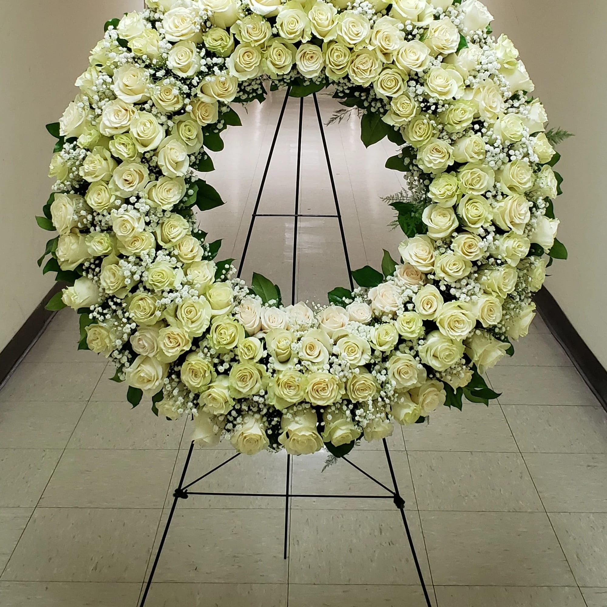 Large white rose wreath on a black stand, photo 2 of 2