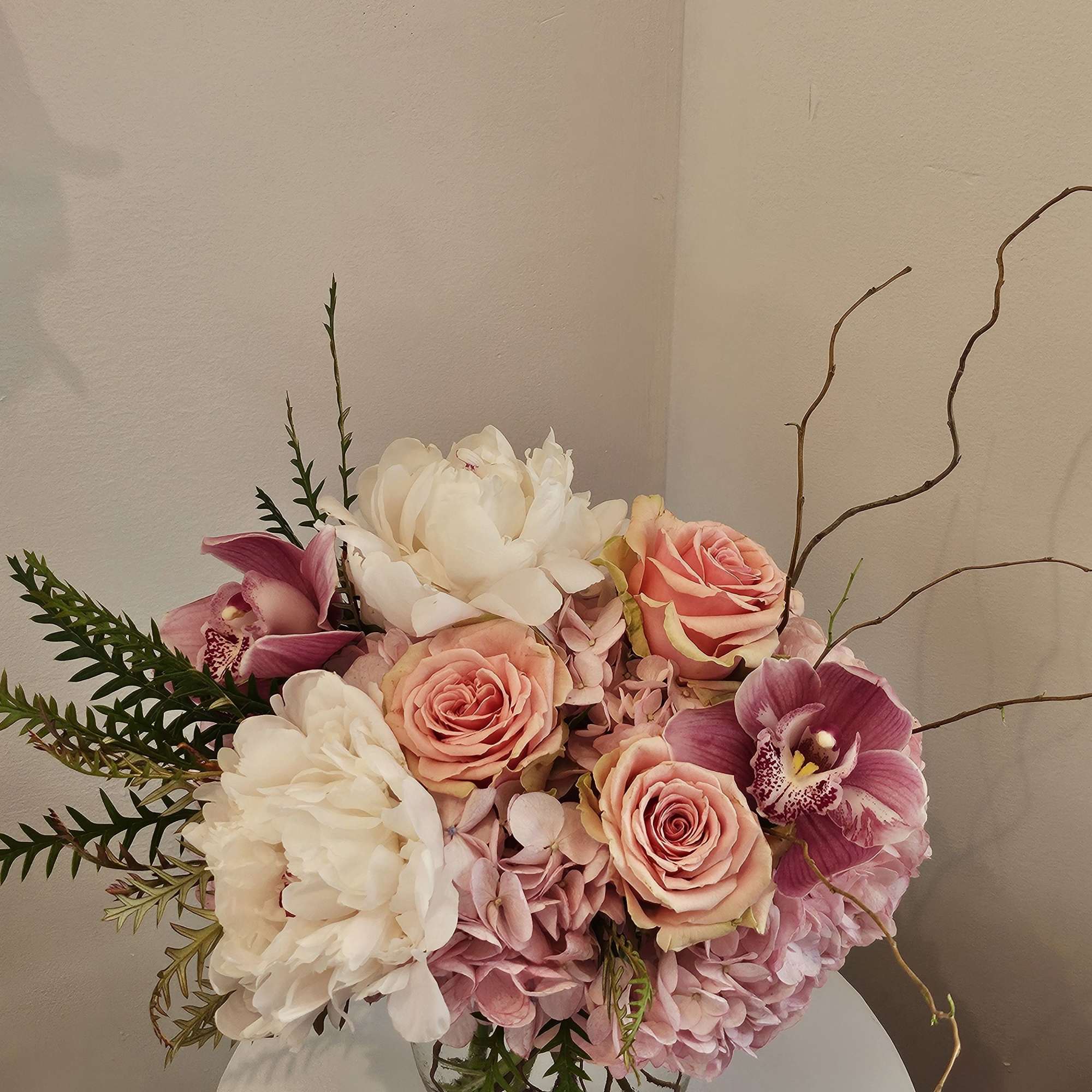 Pink and white floral arrangement in a glass vase