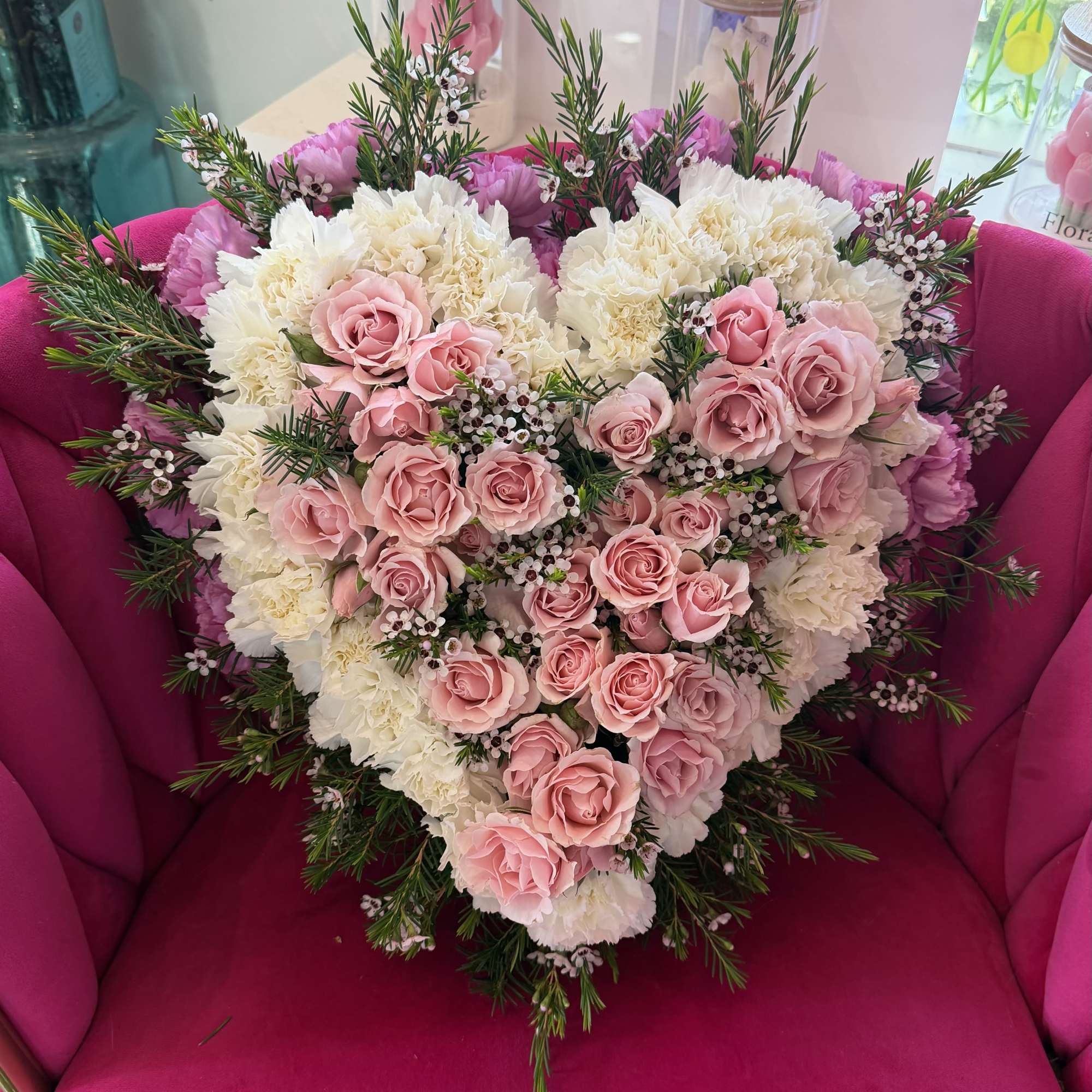 A heart-shaped floral arrangement of blush pink roses layered over creamy white, photo 2 of 2