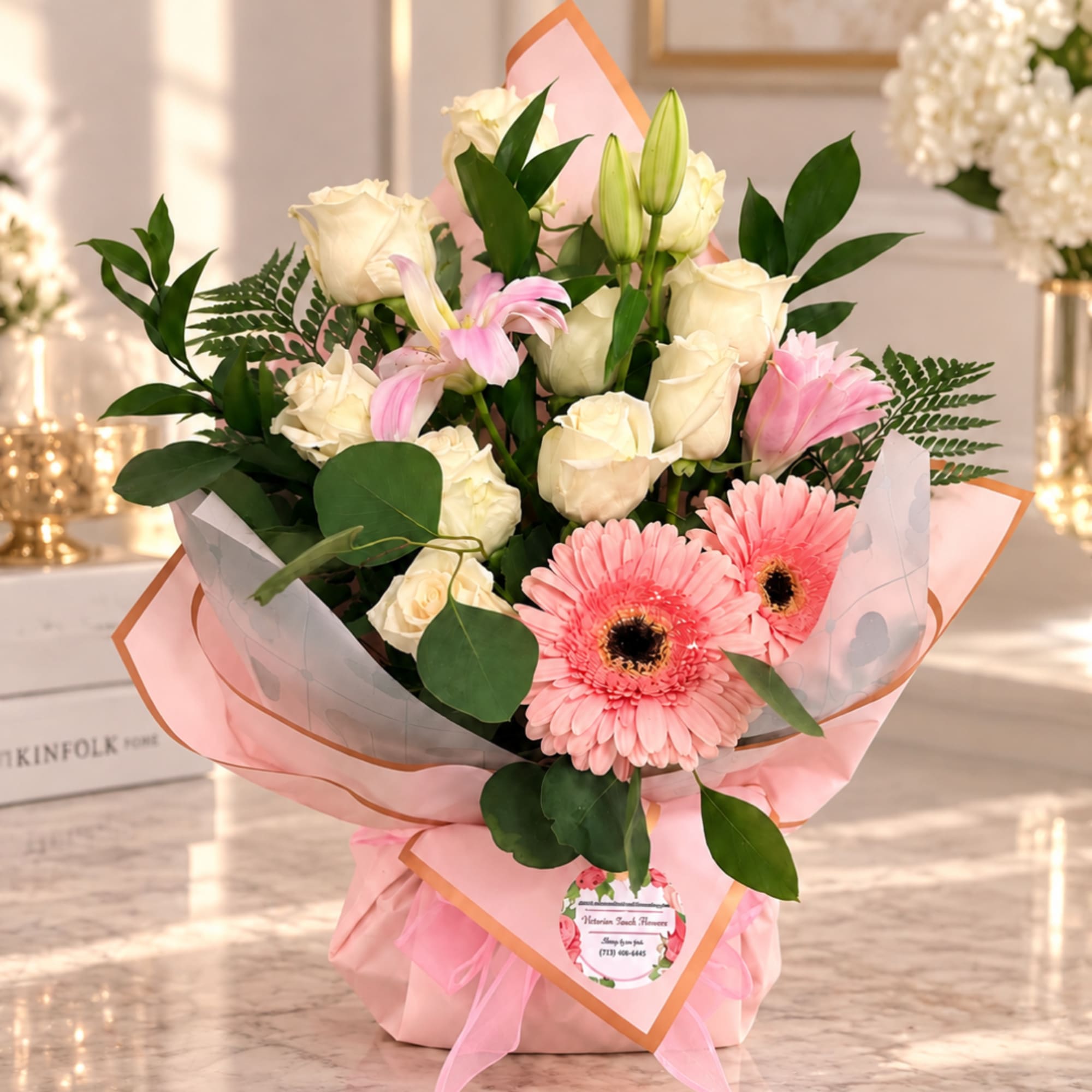 Pink gerbera daisies and white roses in pink wrapping
