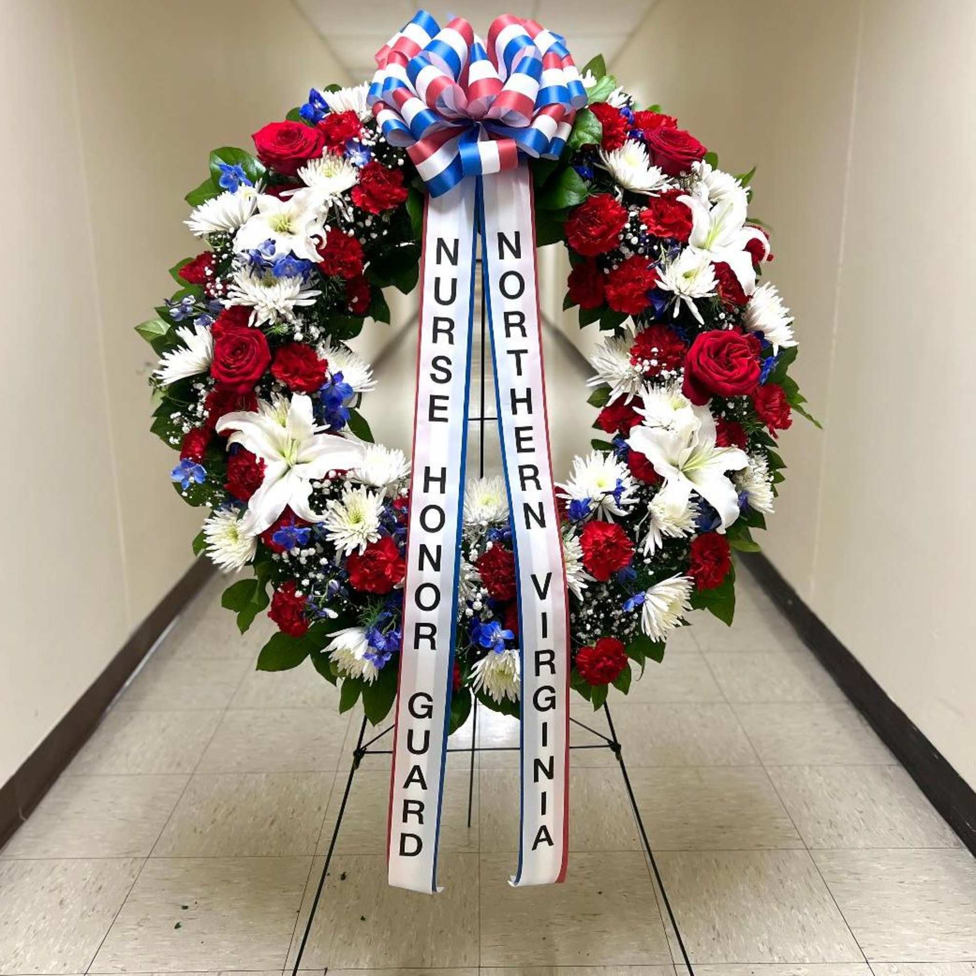 TT-ANC3:   36" DIAMETER RED, WHITE, AND BLUE WREATH ON EASEL

INCLUDES