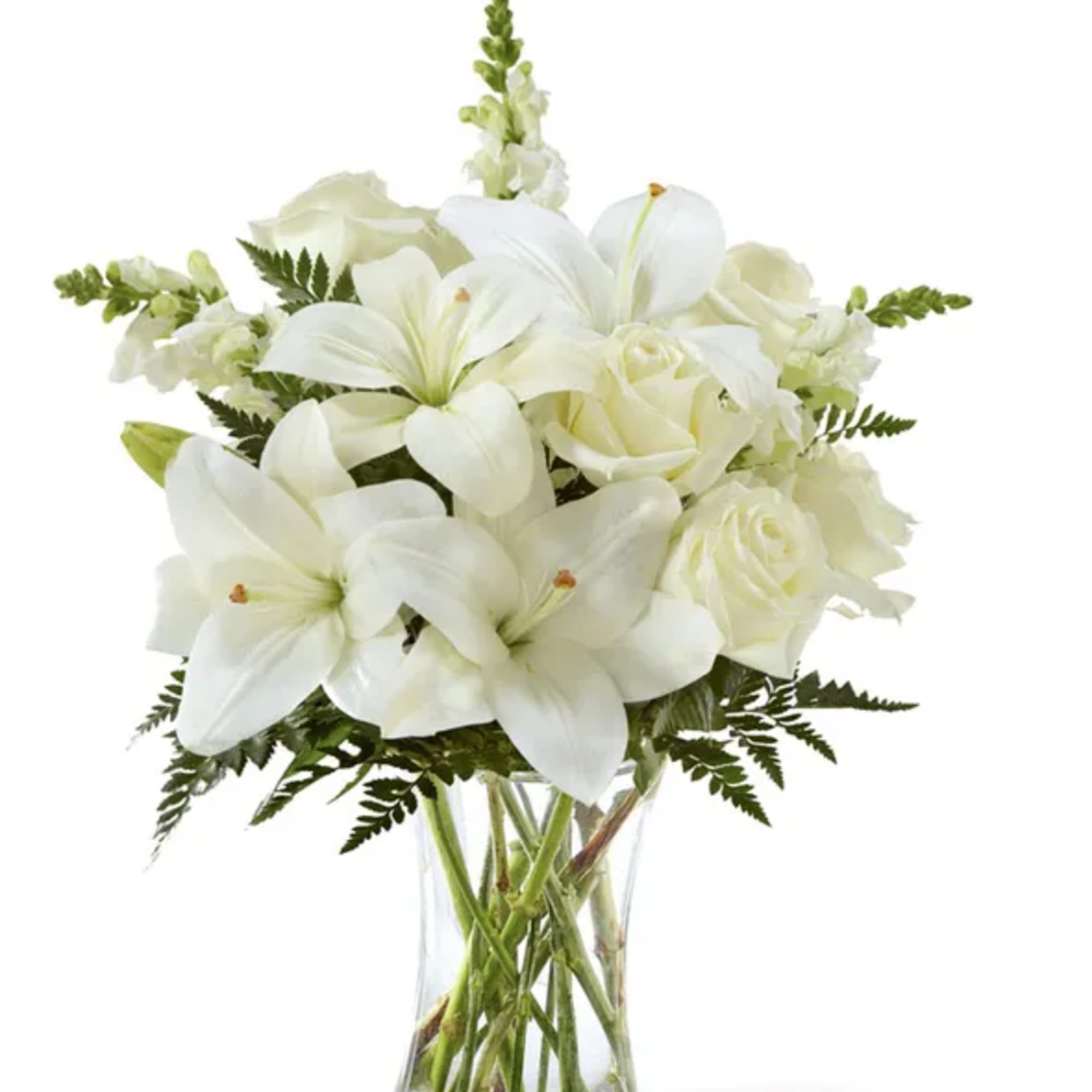 White lilies and roses arranged in a clear glass vase