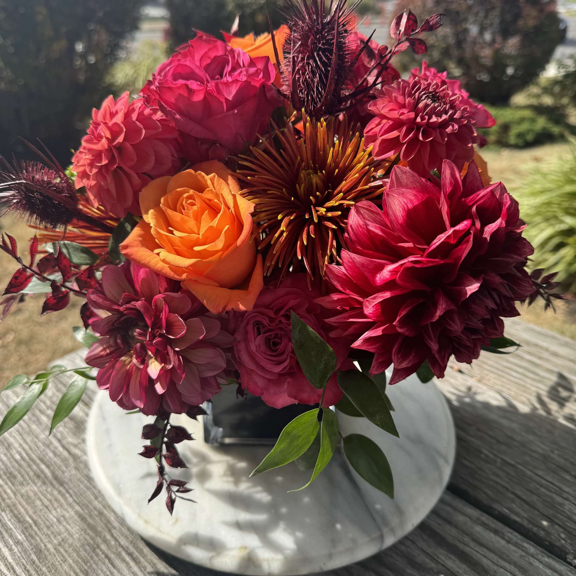 Bright pink and orange bouquet in a white vase