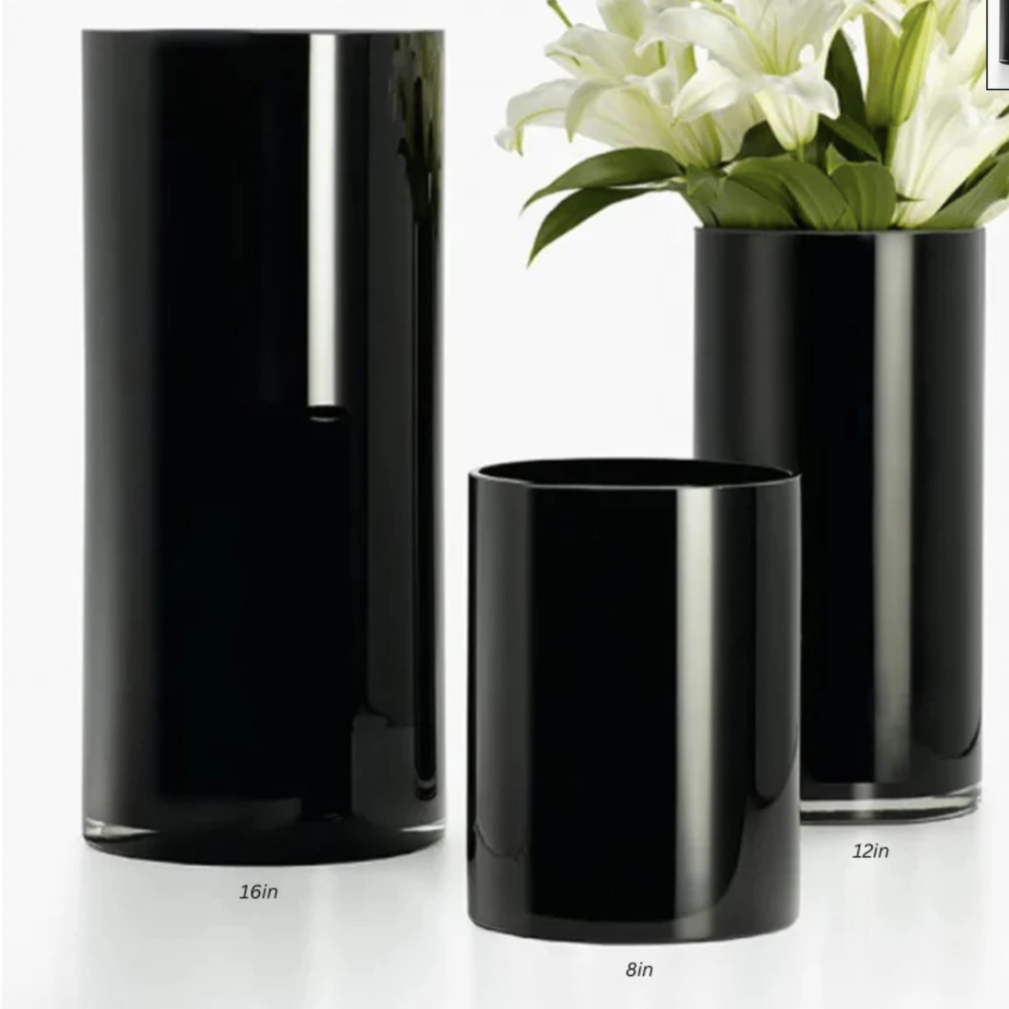 Black cylindrical vases with white lilies